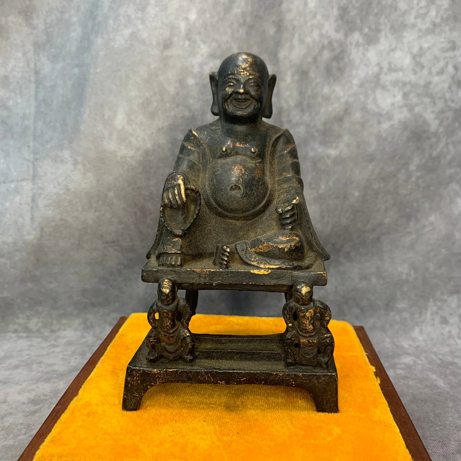 A FINE BRONZE LAUGHING BUDDHA STATUE: 20th Century; High: 5.9 inch; Width: 3.7 inch; Wooden base for diplay only