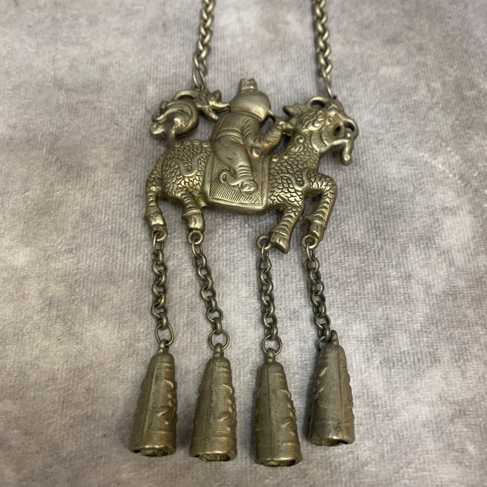 A FINE FINE WHITE BRASS "QILIN DELIVERING A SON" (QILIN SONGZI) NECKLACE: Republic Period; High: 14.0 inch; Wooden base for diplay only