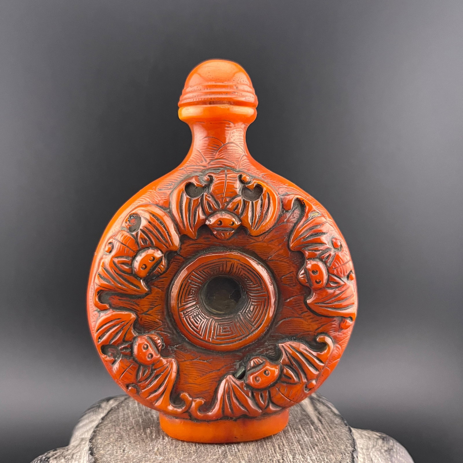 CARVED CINNABAR-STYLE SNUFF BOTTLE: Modern; Long: 2.9 inch; Width: 1.3 inch; High: 3.9 inch; Wooden base for diplay only