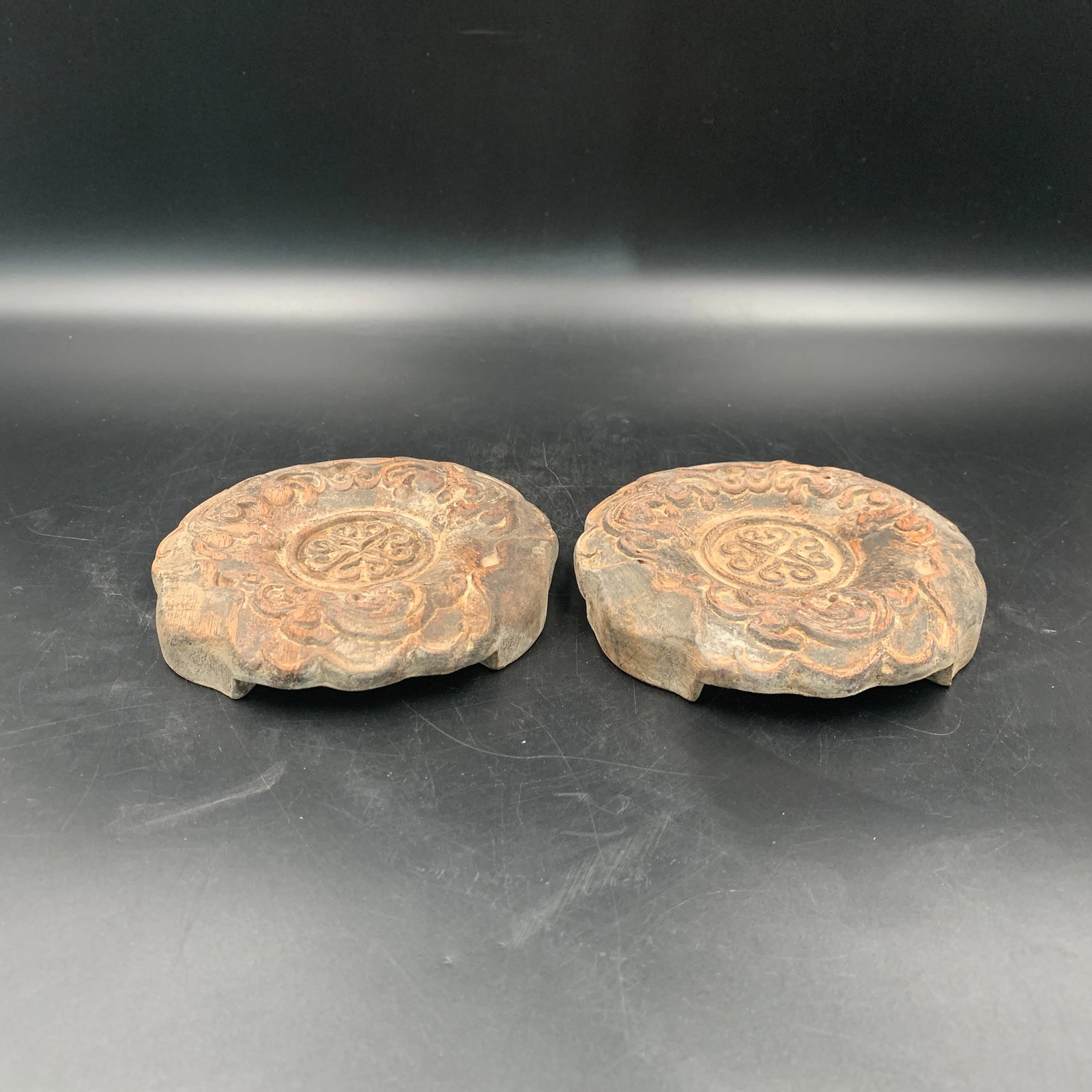 A PAIR OF CARVED EARTHENWARE LOTUS-FORM ROOF END TILES (WADANG)