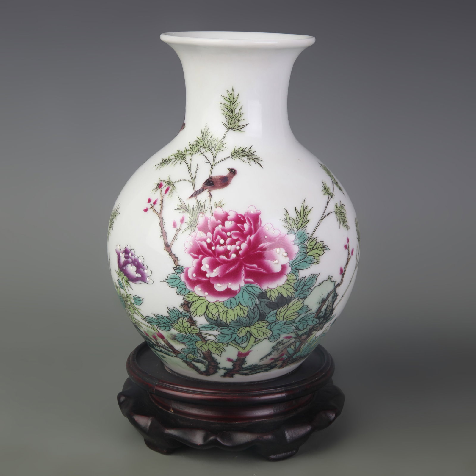 A FAMILLE ROSE VASE WITH BIRD AND FLOWER DECORATION: Qing Dynasty Qian Long Period; Diameter: 3.3 inch; High: 7.3 inch; Wooden base for diplay only