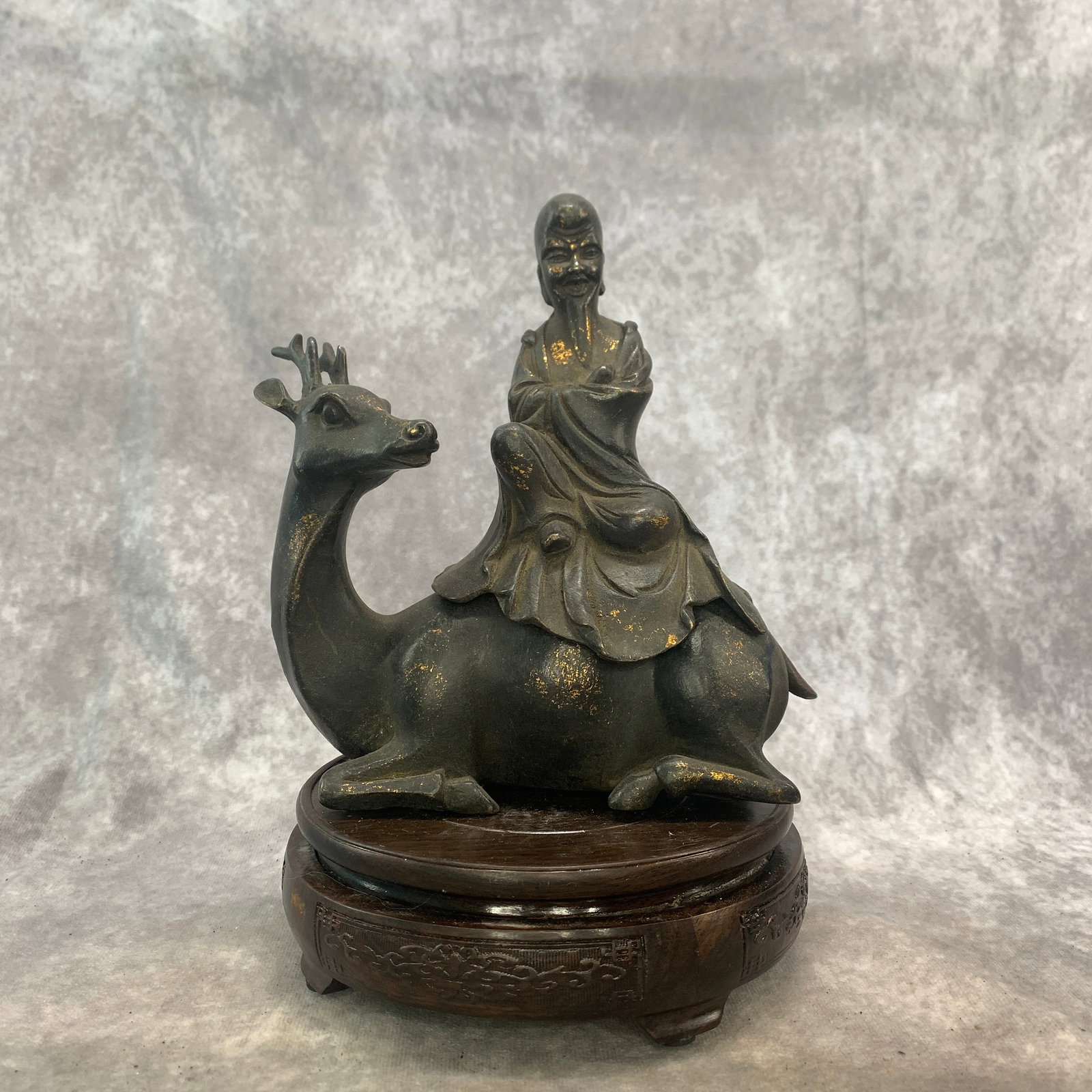 A GILT BRONZE CENSER IN FIGURE OF SHOULAO SEATED ON DEER