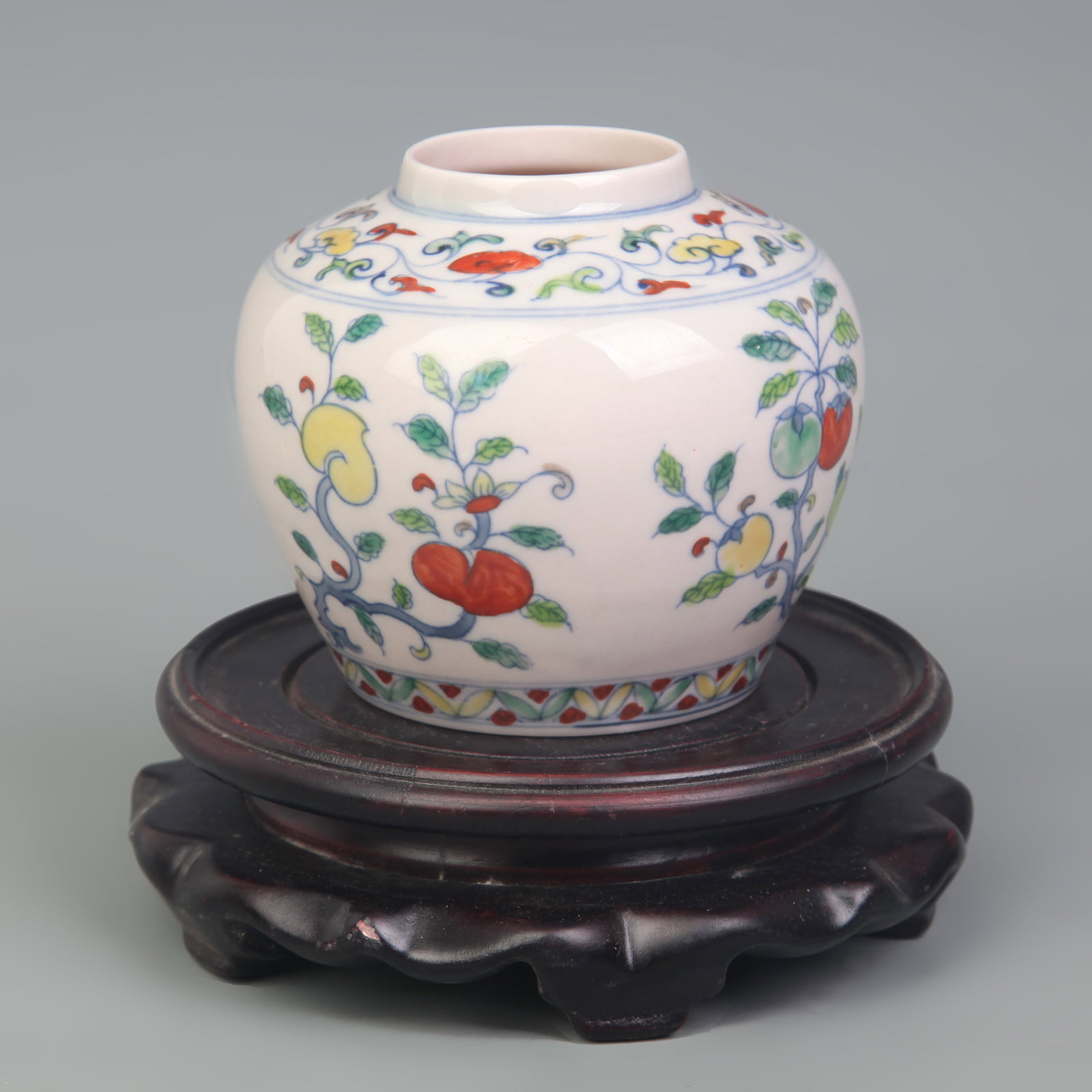 DOUCAI FLORAL AND FRUIT PATTERN SMALL JAR: Republic Period; Diameter: 2.6 inch; High: 3.2 inch; Width: 3.6 inch. Wooden base for display only
