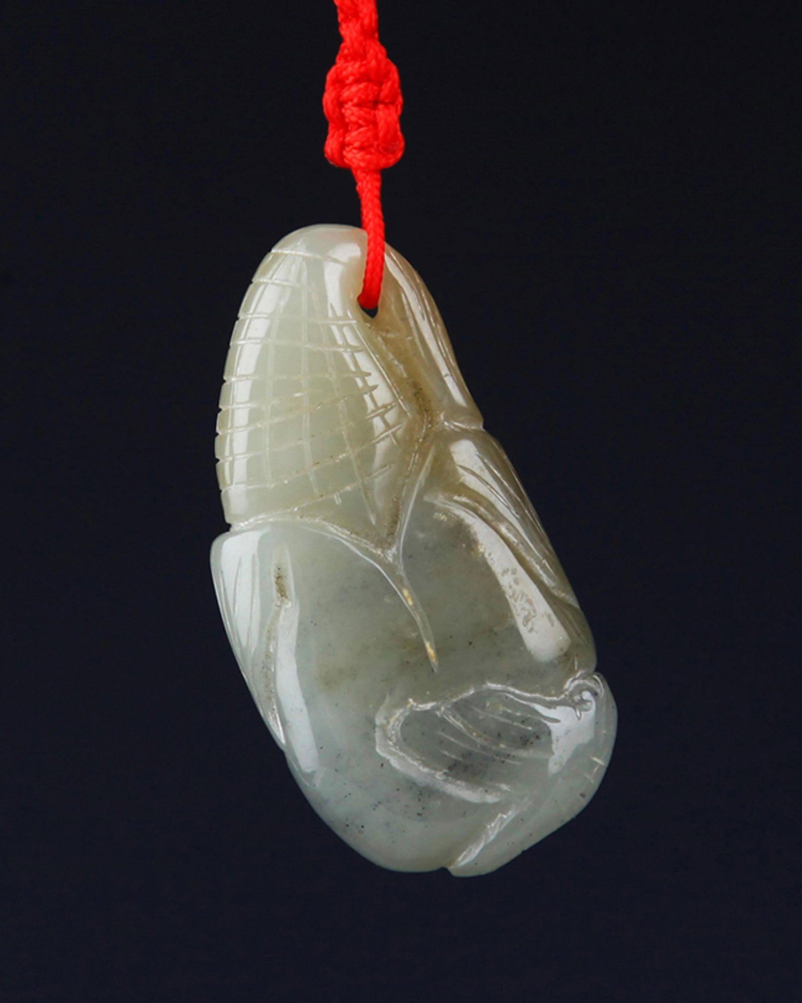 A FINE HE TIAN JADE PENDANT: Contemporary; High: 1.75 inch??????€????????? 1.0 inch. Wooden base for display only