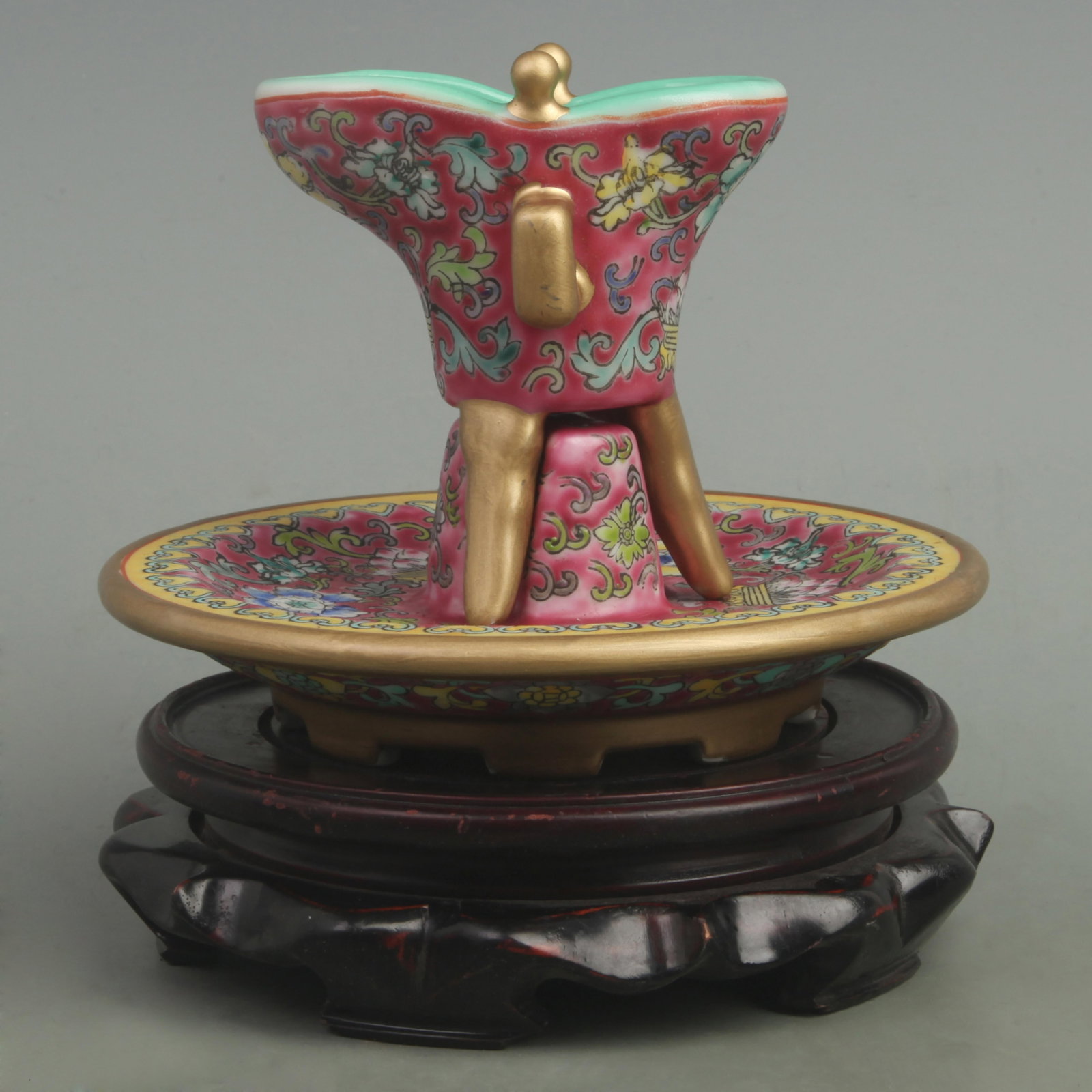 RARE FAMILLE ROSE RED GROUND JUE STYLE WIN CUP: Qing Dynasty Yong Zheng Period; High: 5.5 inch Diameter: 4 inch . Wooden base for display only