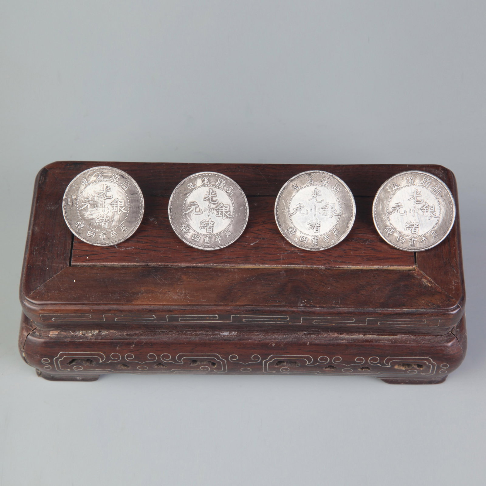 GROUP OF FOUR OLD CHINESE COIN: 19th Century; Diameter: 1.3 inch. Wooden base for display only