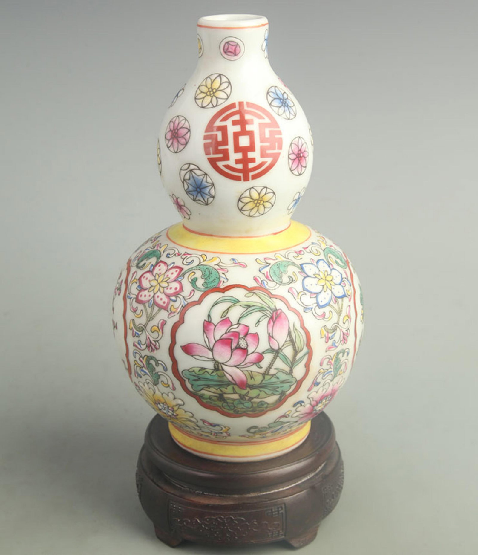 FAMILLE ROSE ENAMELED GOURD-SHAPED BOTTLE WITH LOTUS DESIGN: Qing Dynasty Qian Long Period; High: 9.20 inch; Width: 5.00 inch; . Wooden base for display only
