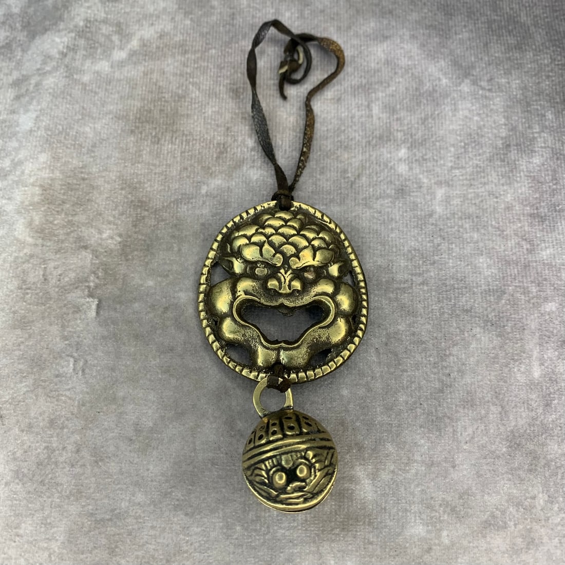 TIBETAN BUDDHIST BRONZE PENDANT: Modern; High: 3.4 inch Width: 2.0 inch. Wooden base for display only