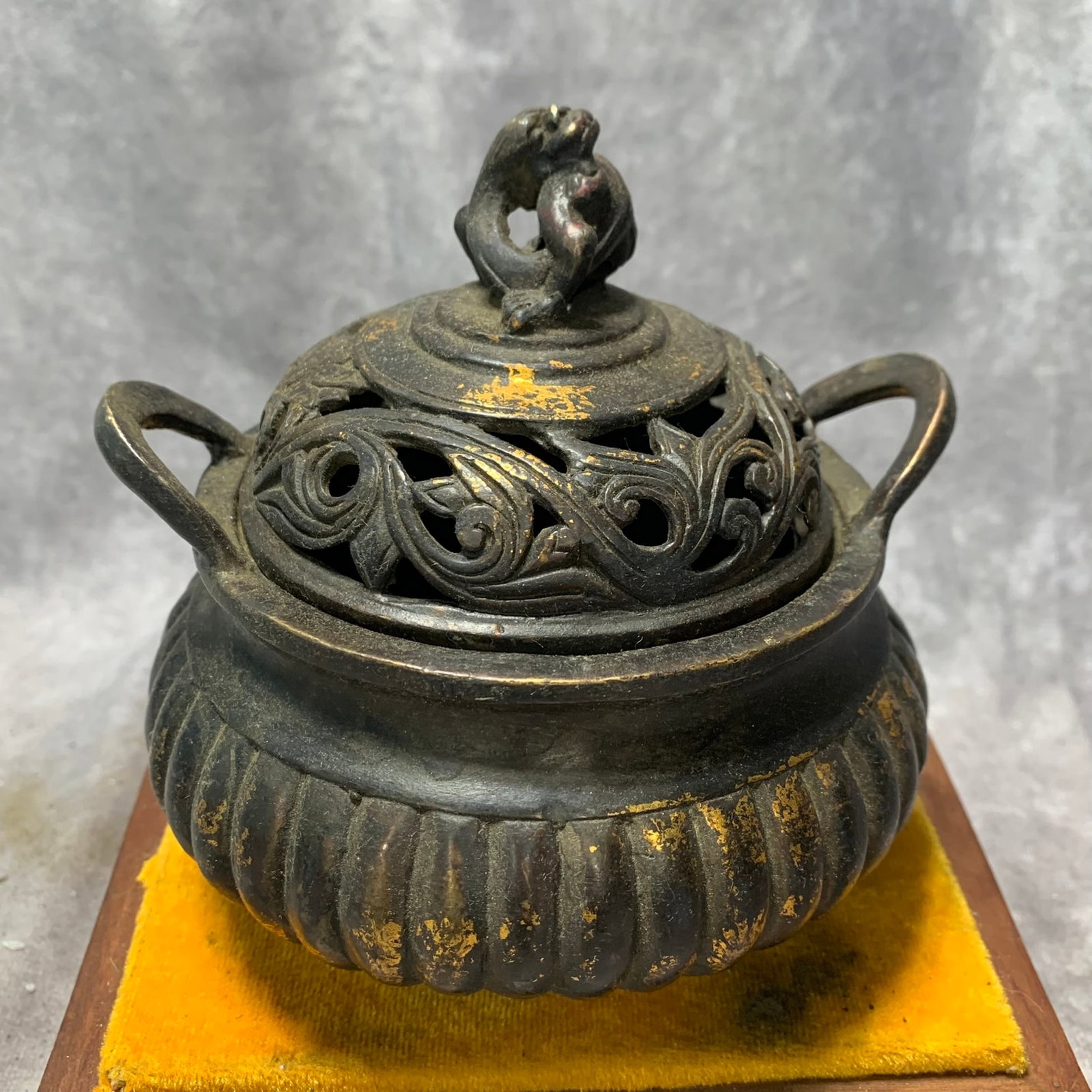 QIAN LONG MARK GILT BRONZE CHI DRAGON-LID MELON-FORM TRIPOD INCENSE BURNER: Qing Dynasty; High: 5.4 inch; Diameter: 5.1 inch; . Wooden base for display only