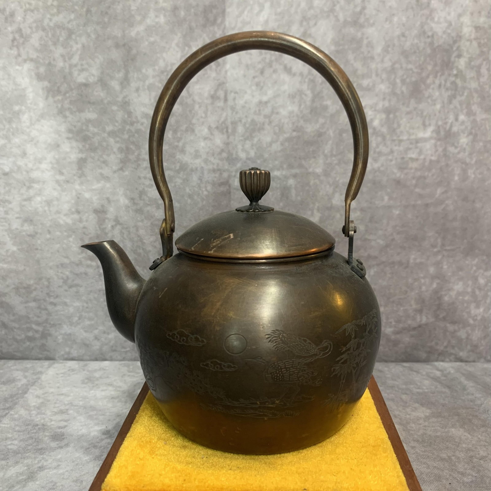 A FINELY CARVED BRONZE WATER KETTLE: 20th Century; High: 8.9 inch; Width: 6.9 inch; Long: 5.6 inch. Wooden base for display only