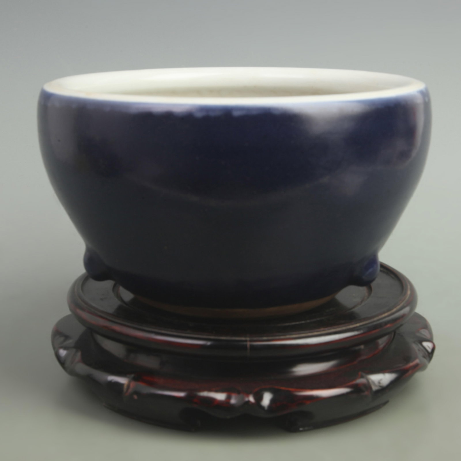 A FINE DARK BLUE GLAZED PORCELAIN INCENSE BURNER: Qing Dynasty; High: 5.5 inch; Width: 9.5 inch; . Wooden base for display only