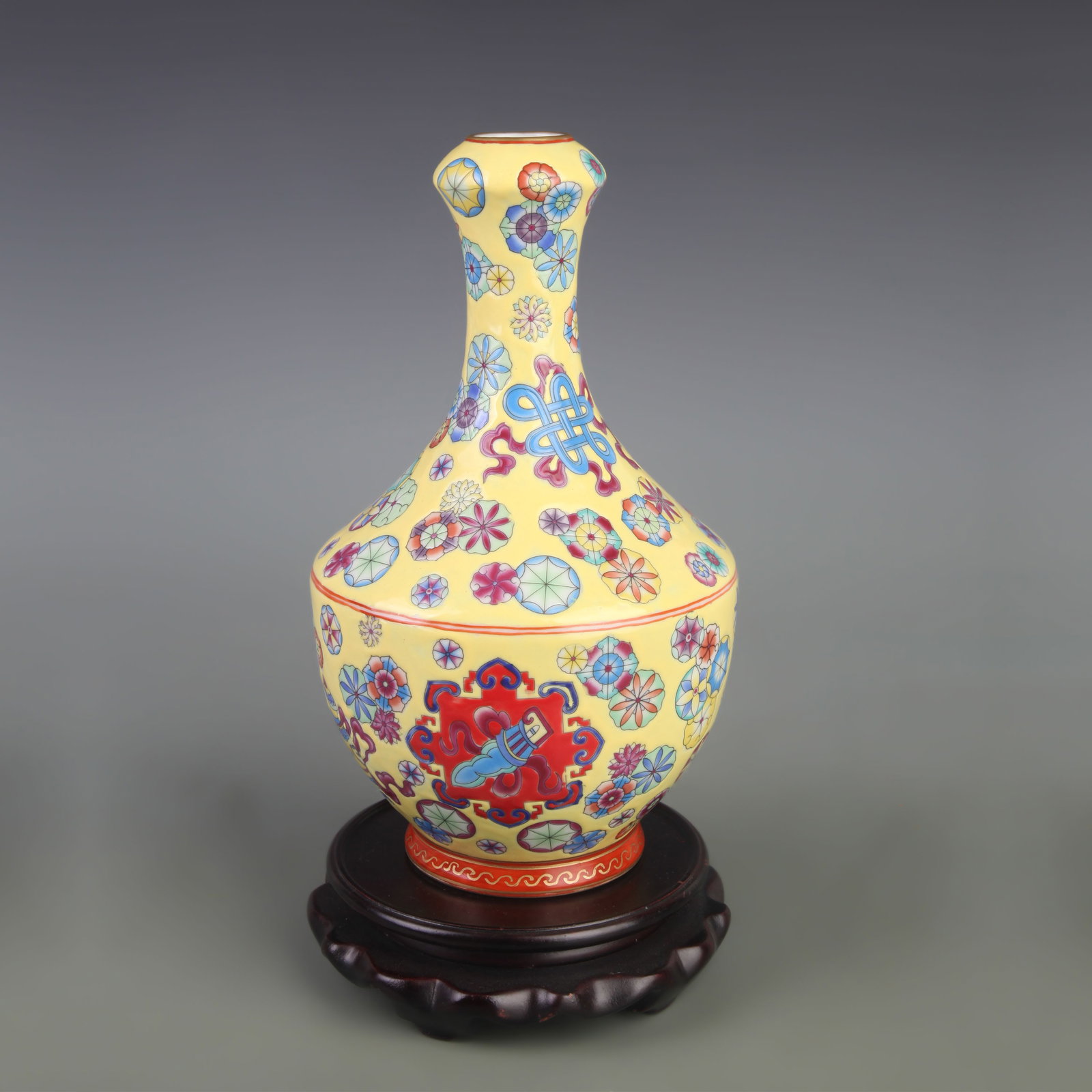 A FAMILLE-ROSE YELLOW-GROUND FLORAL PATTERN PORCELAIN VASE: Qing Dynasty Yong Zheng Period; Diameter: 5.8 inch; High: 9.8 inch; wooden base for picture and display purpose only.