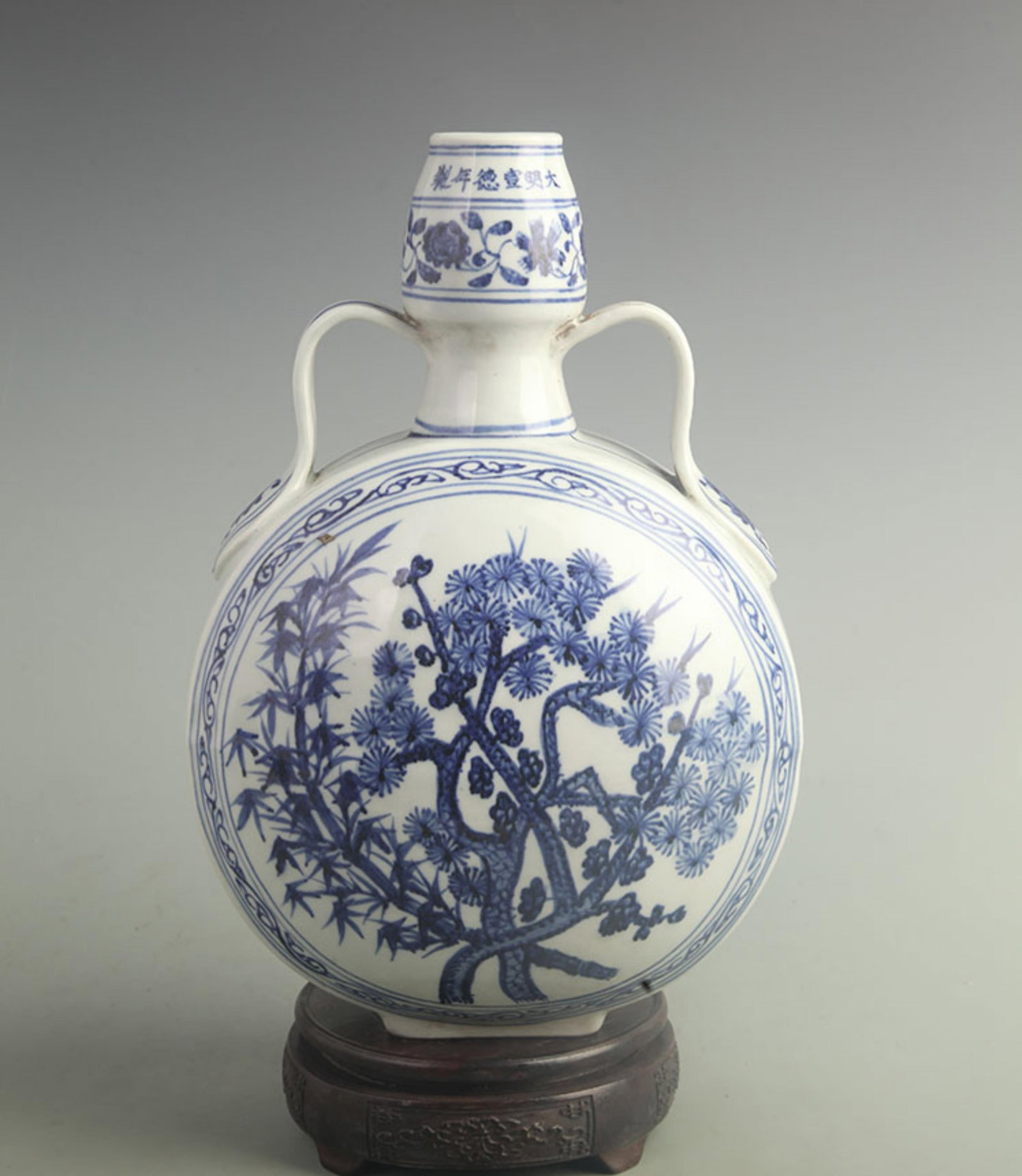 BLUE AND WHITE PINE, BAMBOO, AND PLUM PATTERN MOON STYLE BOTTLE: Ming Dynasty Style; High: 12.0 inch; Width: 8.00 inch; wooden base for picture and display purpose only.