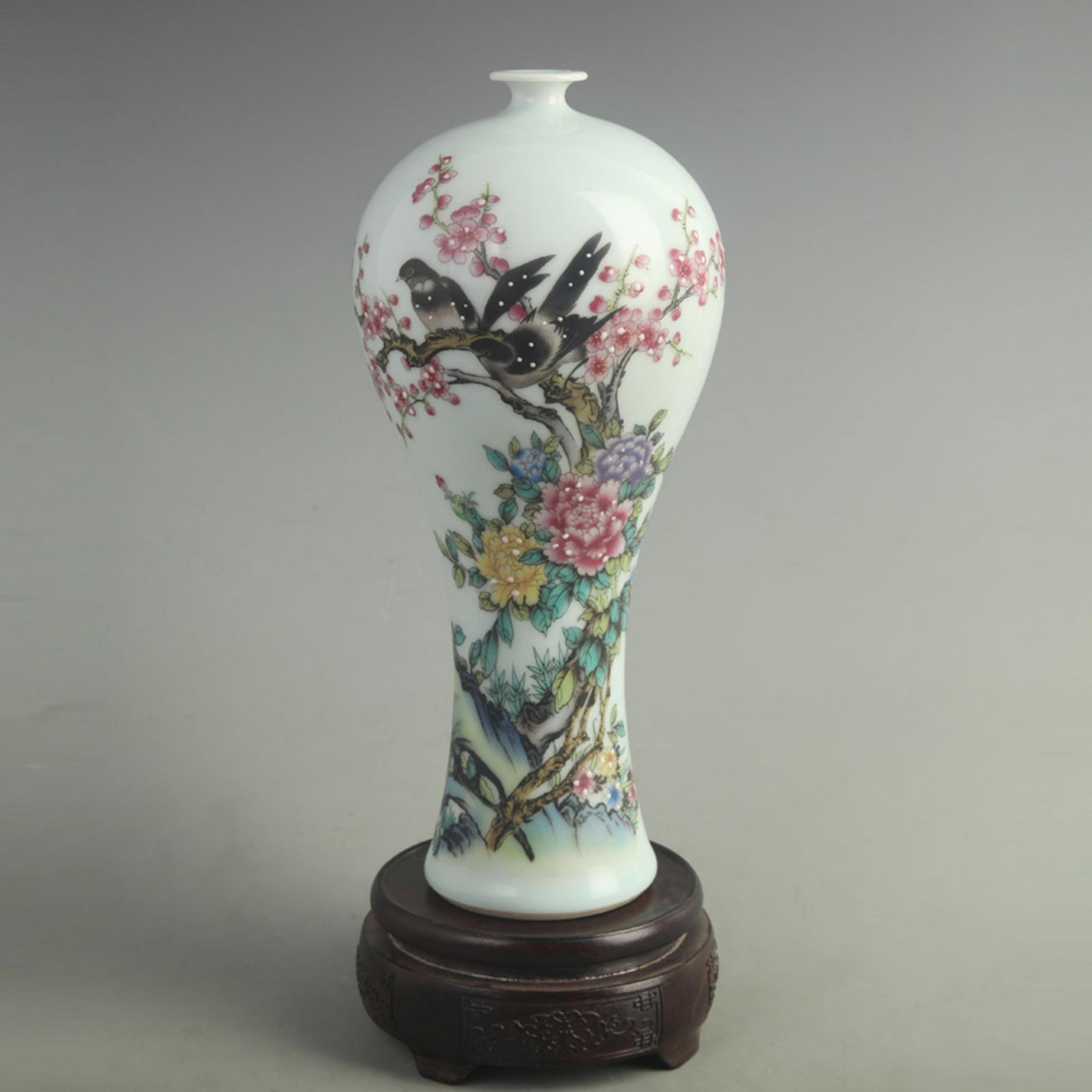 ENAMEL COLOR PAINTED PEONY AND PLUM BLOSSOM PORCELAIN VASE: Qing Dynasty Qian Long Period; High: 11.0 inch; Width: 4.50 inch; wooden base for picture and display purpose only.