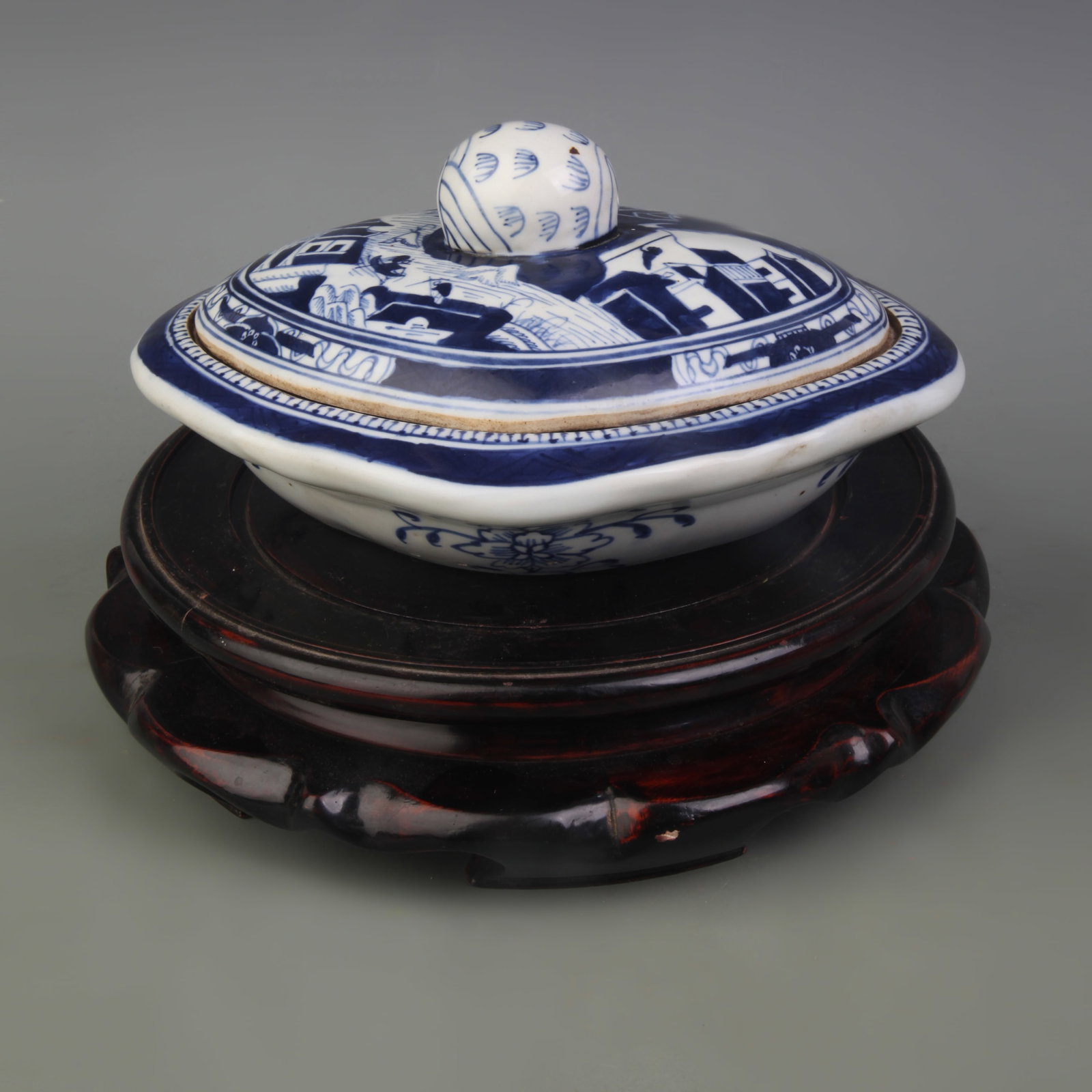A BLUE-AND-WHITE COVERED DISH WITH LANDSCAPE AND FIGURAL DECORATION: Qing Dynasty; Width: 8.7 inch; High: 3.10 inch; wooden base for picture and display purpose only.