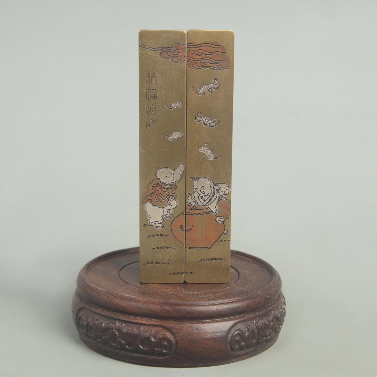 BRONZE AND SILVER INLAY NE ZHA NAO HAI FIGURE PAPER WEIGHT: Republic Period; High: 4.25 inch; Width: 0.75 inch; wooden base for picture and display purpose only.