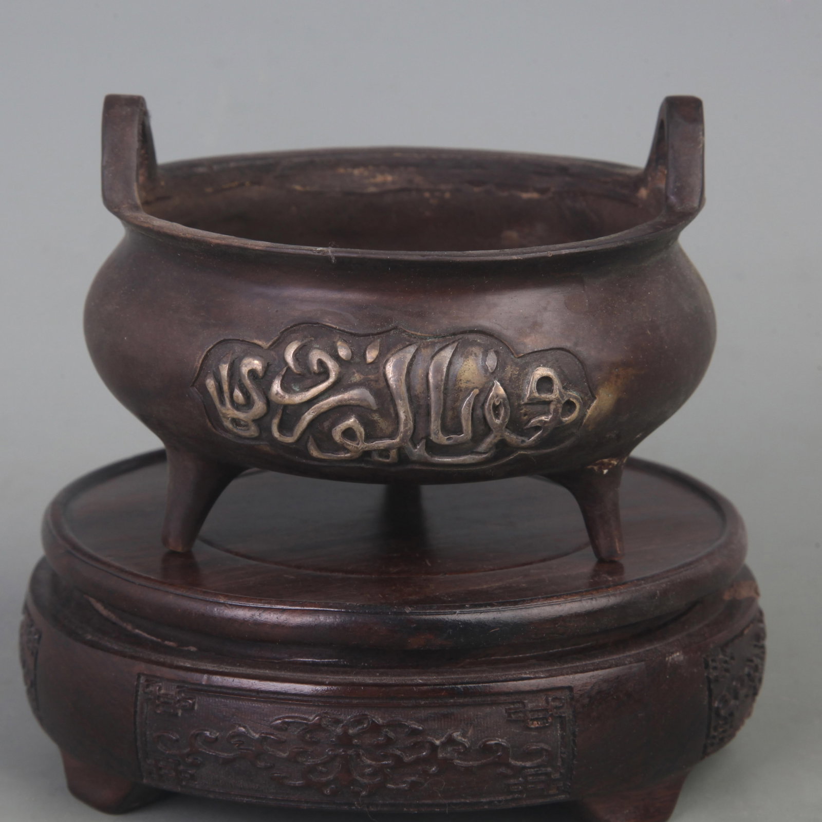 A FINE THREE-LEGGED STOVE WITH BRIDGE-SHAPED EARS CENSER: Ming Dynasty Style; Diameter: 4.3 inch; High: 3.3 inch; wooden base for picture and display purpose only.