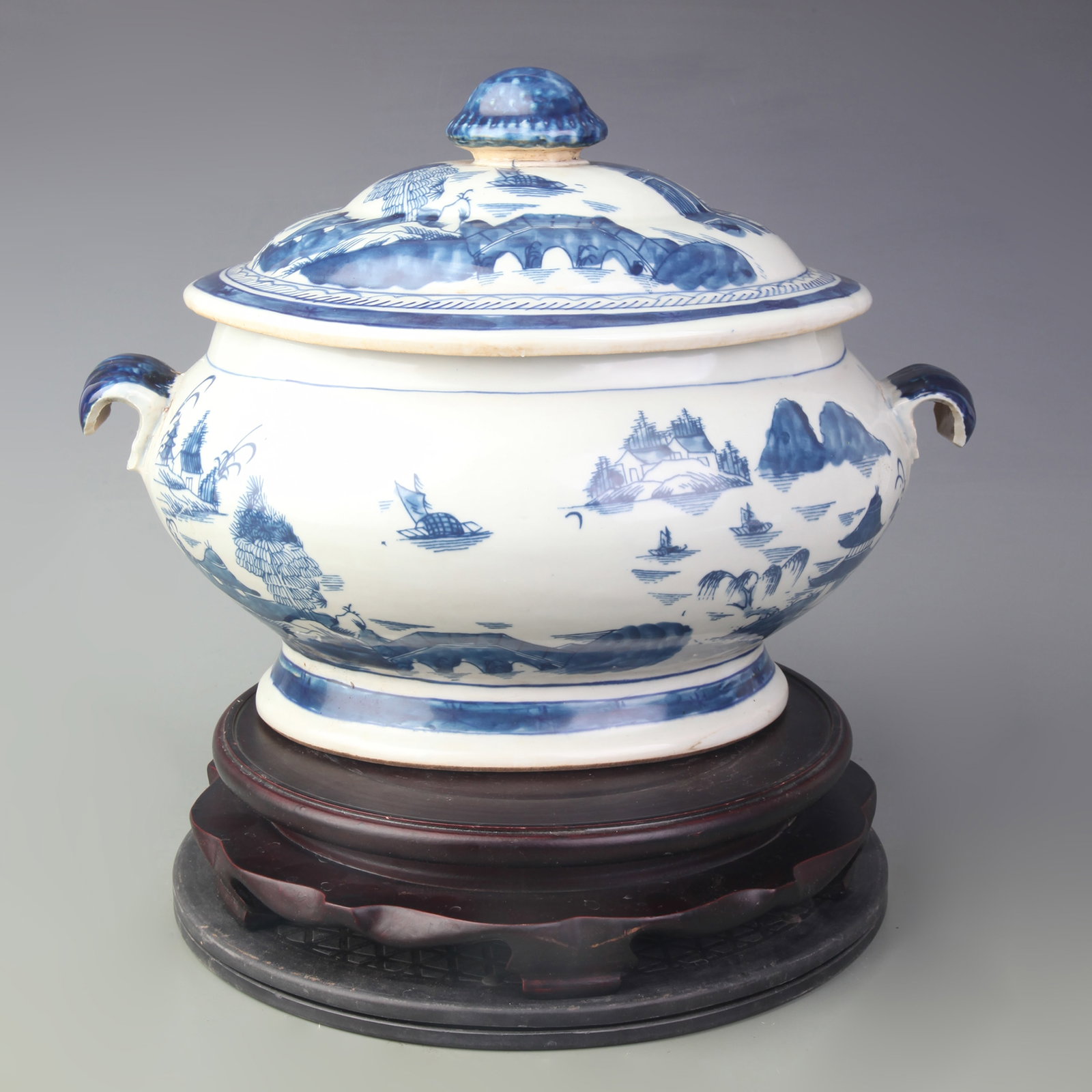 A BLUE AND WHITE LANDSCAPE DOUBLE-HANDLED JAR: Qing Dynasty; Long: 14.5 inch; High: 10.6 inch; wooden base for picture and display purpose only.