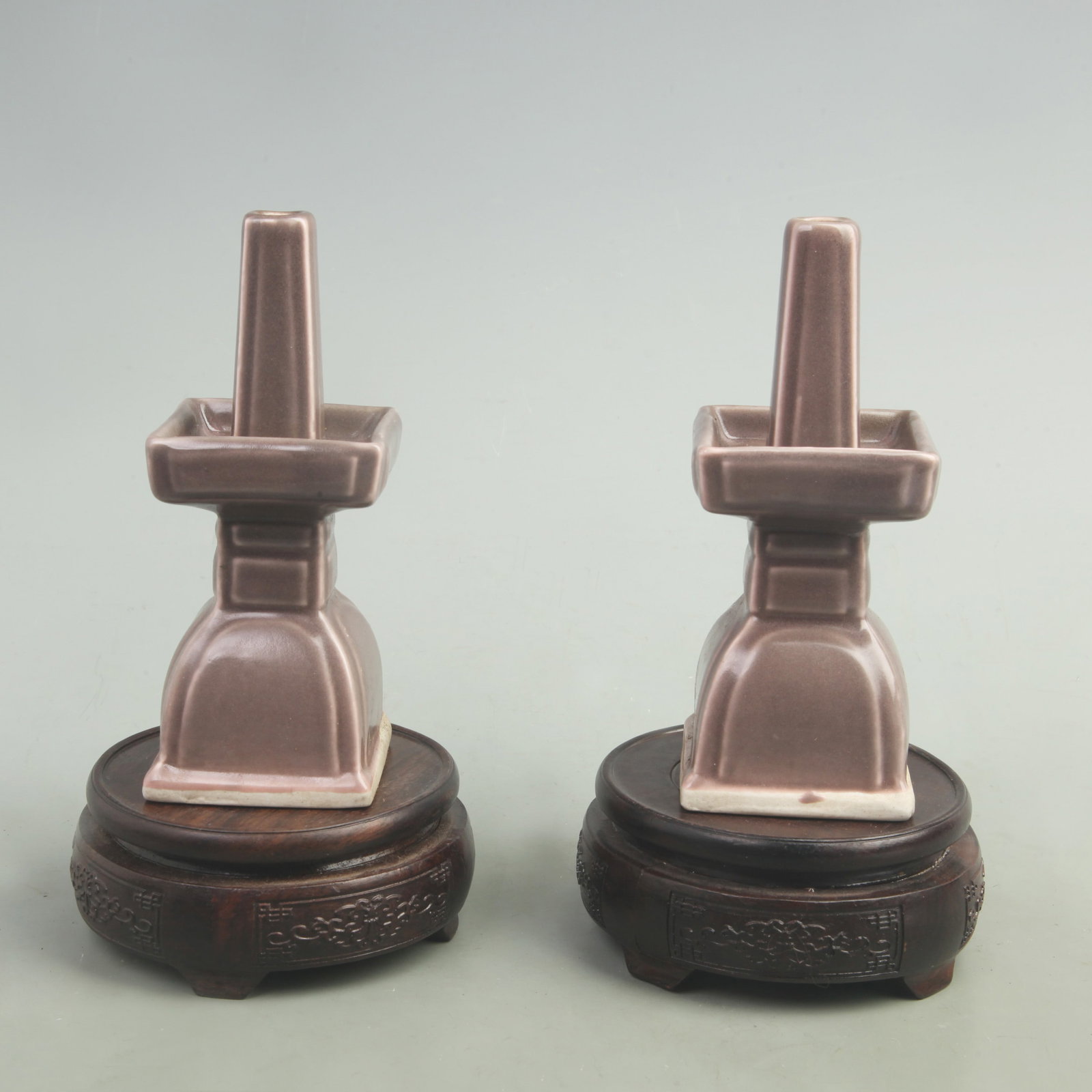 PAIR OF RED COLOR GLAZED PORCELAIN CANDLESTICKS: Qing Dynasty, High: 6.5 inch; High: 2.6 inch; wooden base for picture and display purpose only.