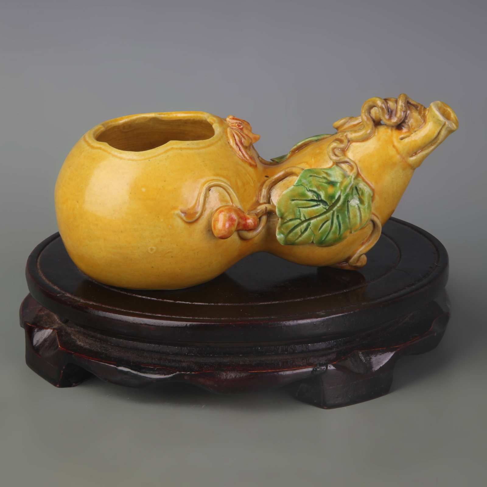 A YELLOW-GLAZED BRUSH WASHER CARVED WITH LONGEVITY AND ???U??CHARACTERS: Qing Dynasty Qian Long Period; Width: 6.2 inch; High: 2.7 inch; wooden base for picture and display purpose only.