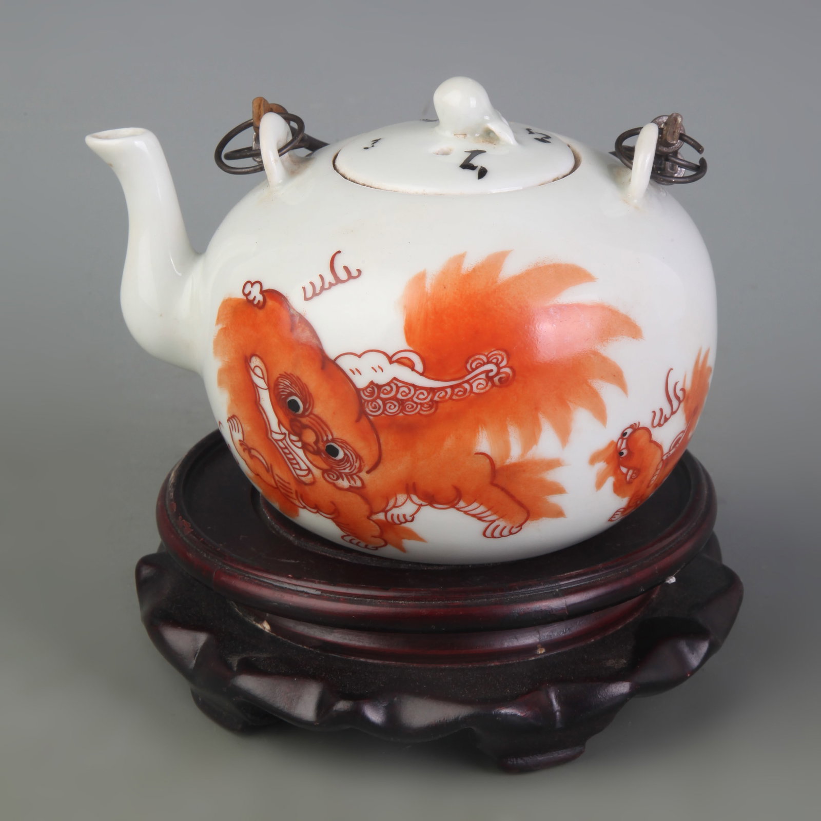 FAMILLE ROSE TEAPOT WITH GRAND TUTOR AND JUNIOR GUARDIAN MOTIF, BAIL HANDLE: Qing Dynasty Tong Zhi Period; Width: 5.2 inch; High:3.6 inch; wooden base for picture and display purpose only.