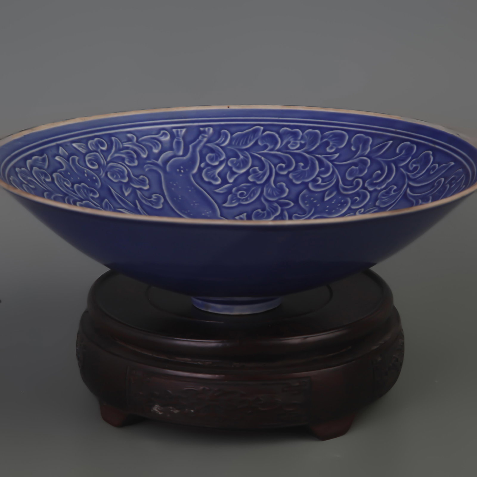 SACRIFICIAL BLUE GLAZED CARVED FLORAL AND BIRD PORCELAIN BOWL: Song Dynasty Style; Diameter: 8.0 inch; High:2.5 inch; wooden base for picture and display purpose only.