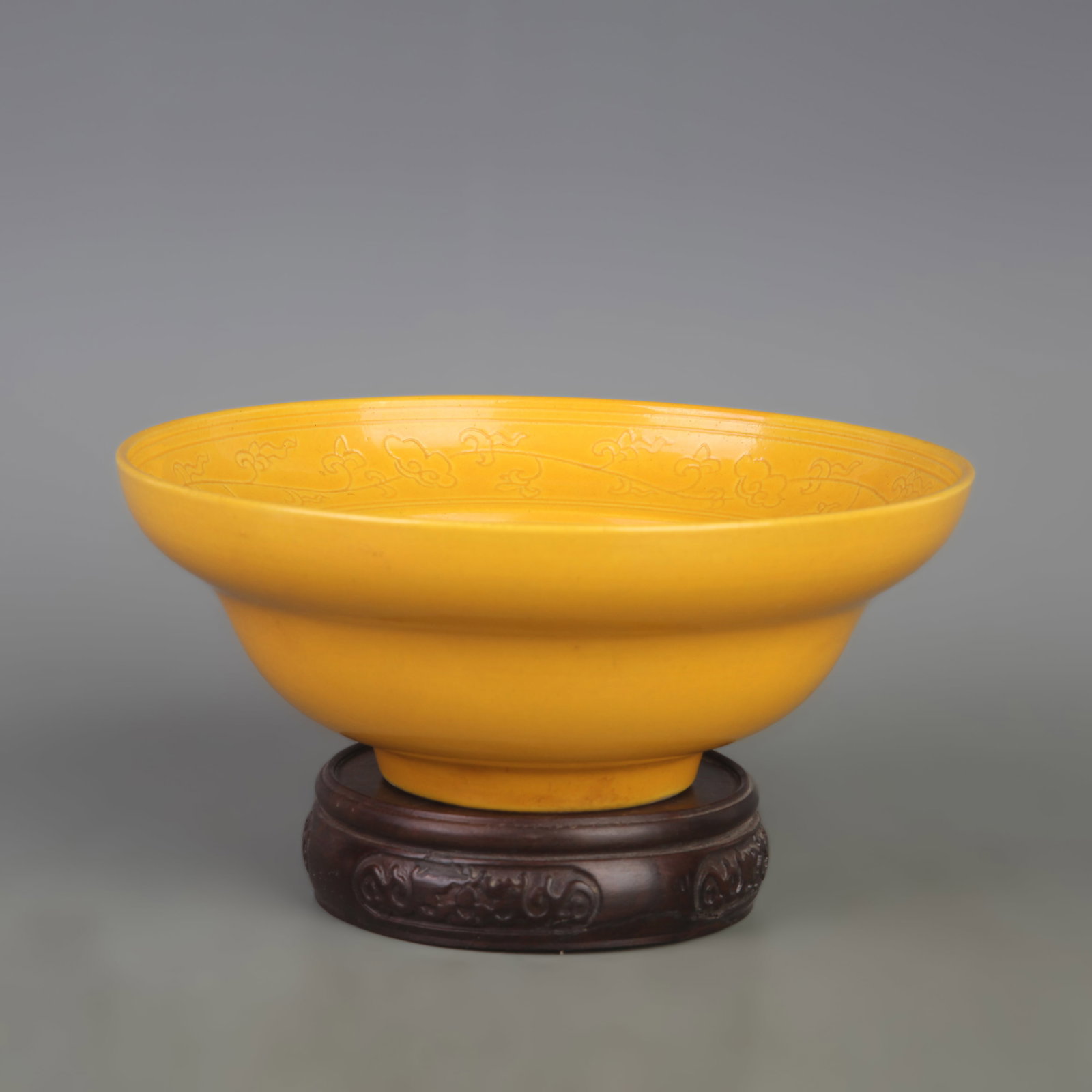 A CHINESE IMPERIAL-YELLOW GLAZED INCISED 'FLORAL' OGEE-FORM BOWL: Ming Dynasty Style Hong Zhi Period; Diameter: 7.0 inch; High: 2.7 inch; wooden base for picture and display purpose only.