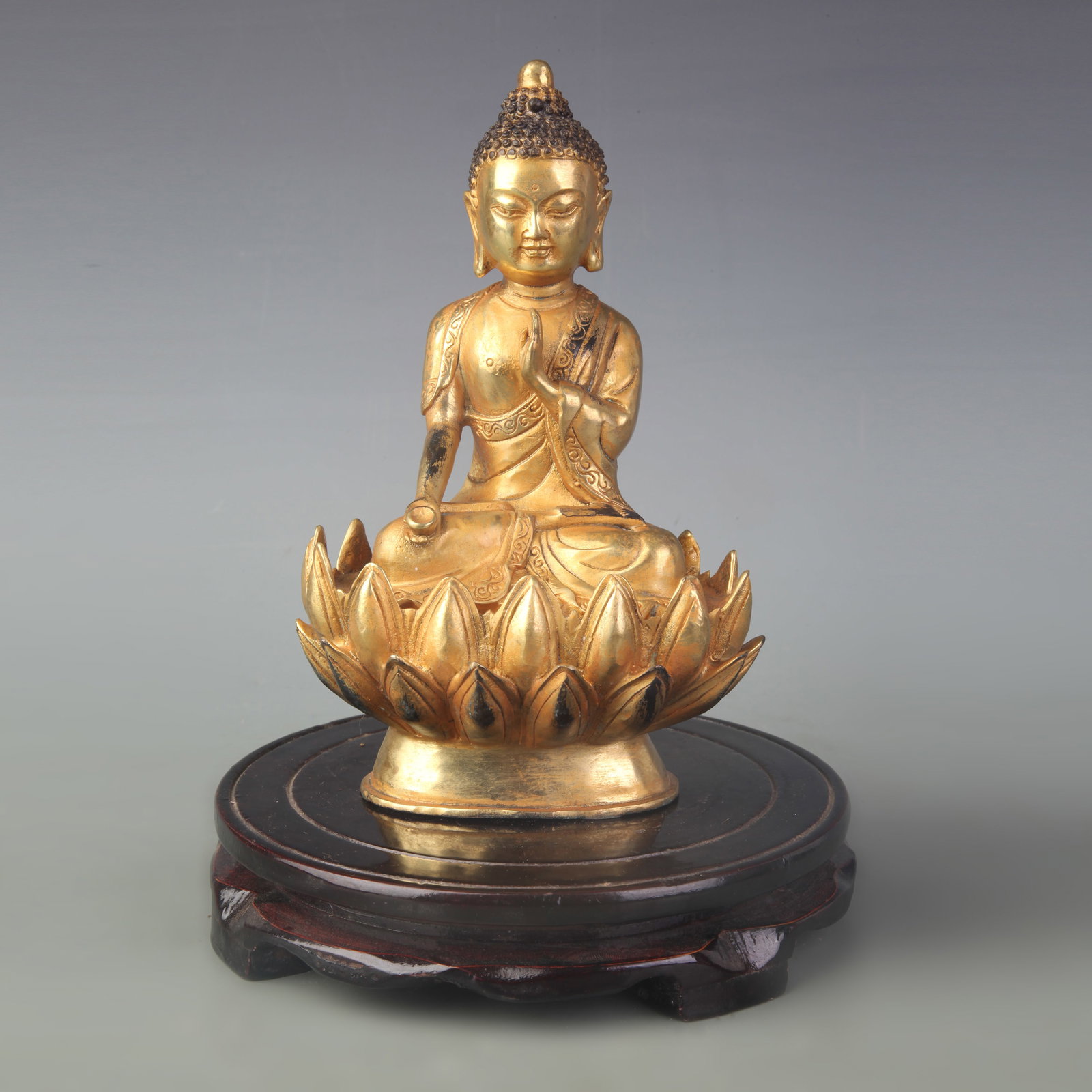 A GILDED BRONZE FIGURE OF SHAKYAMUNI BUDDHA: Qing Dynasty; High: 7.5 inch; wooden base for picture and display purpose only.