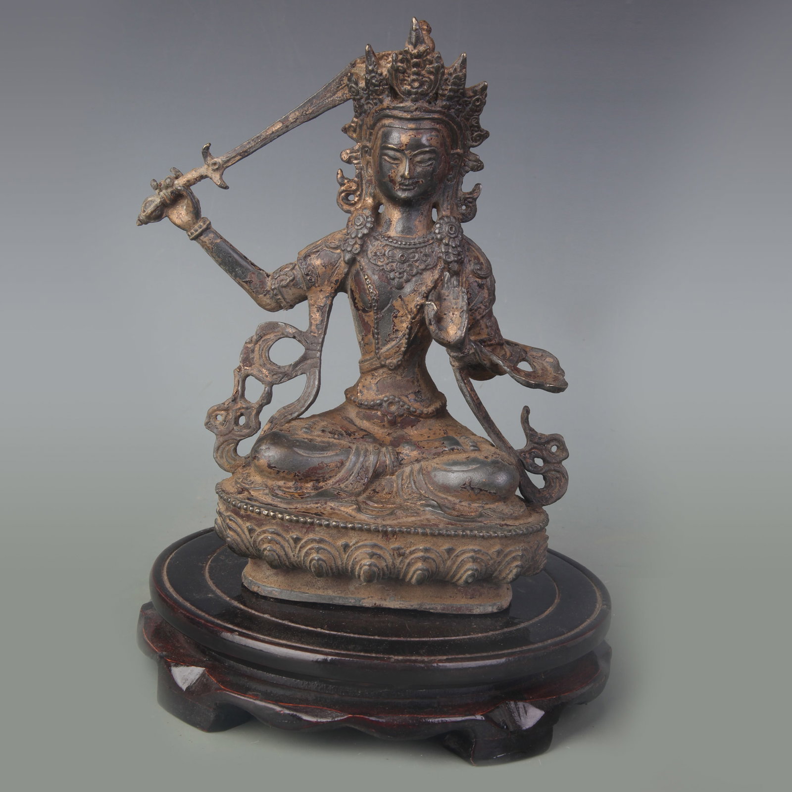A GILT-BRONZE FIGURE OF MANJUSHRI: Qing Dynasty; High: 8.1 inch; wooden base for picture and display purpose only.