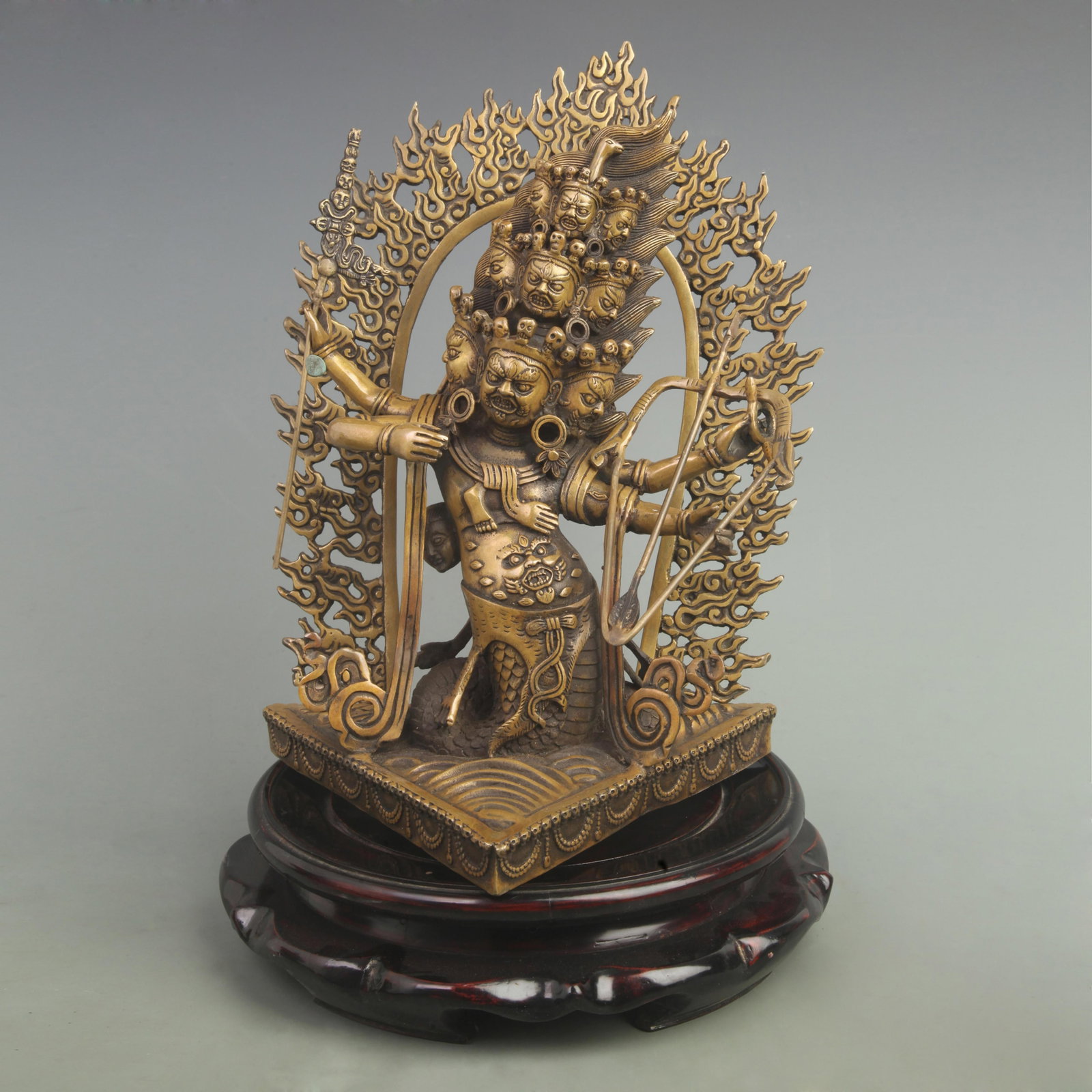 RARE BRONZE NINE-FACED FOUR-ARMED WARRIOR DEITY: Qing Dynasty; High: 12.5 inch; Width: 9.4 inch; wooden base for picture and display purpose only.
