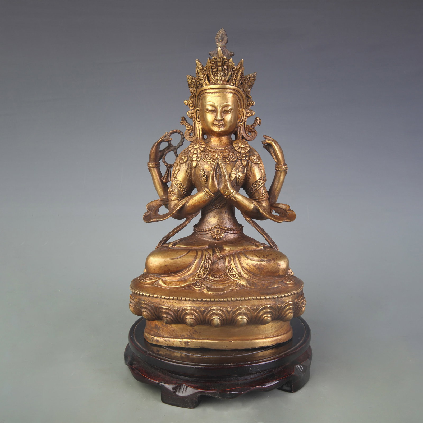 A FINE BRONZE FOUR-ARMED GUANYIN: Qing Dynasty; High: 11.0 inch; wooden base for picture and display purpose only.