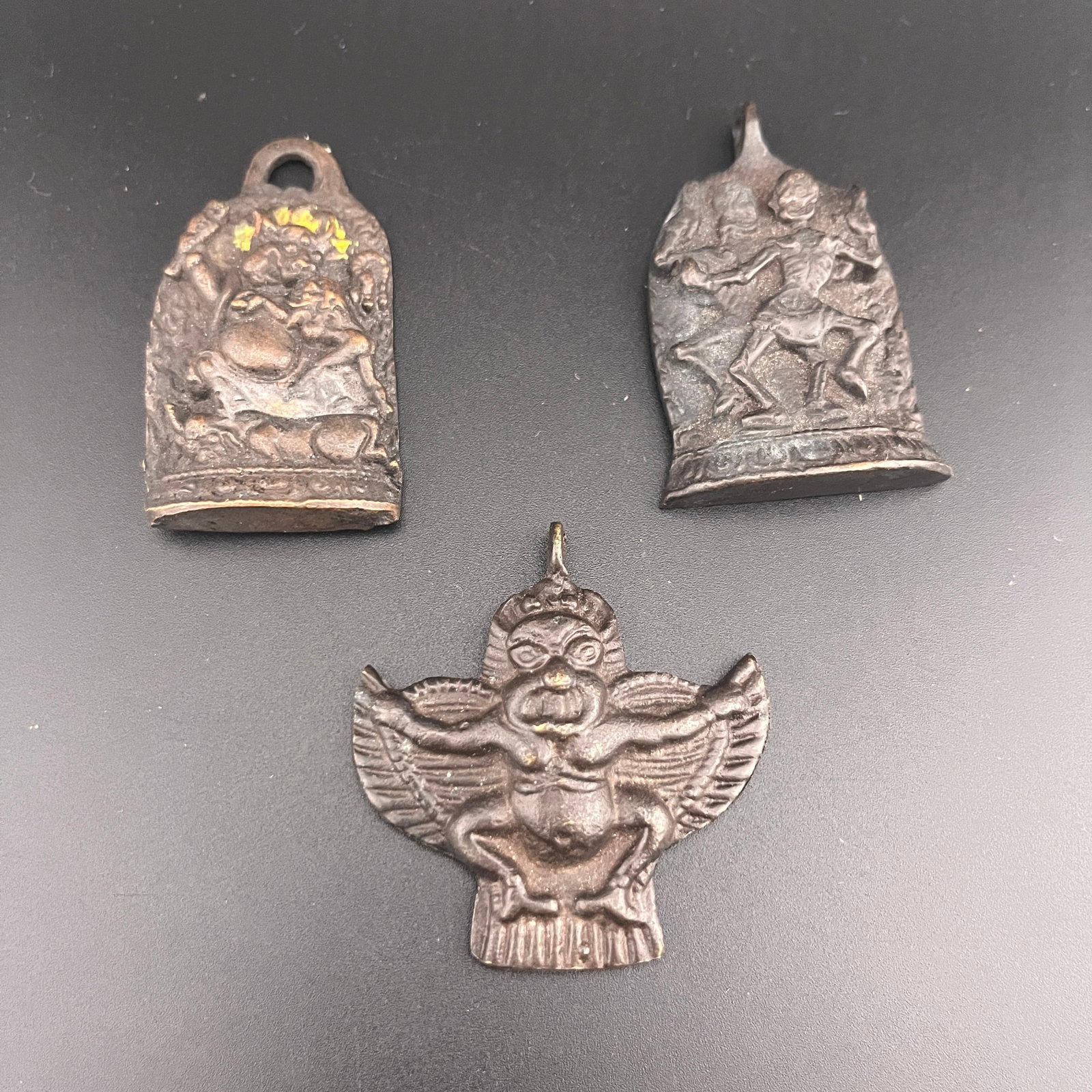 GROUP OF THREE HIMALAYAN PROTECTIVE AMULETS: Qing Dynasty; Long: 2.2 inch; Width: 1.2 inch; High: 0.3 inch; Long: 2.25 inch; Width: 1.35 inch; High: 0.4 inch; Long: 2.1 inch; Width: 1.98 inch; High: 0.38 inch;