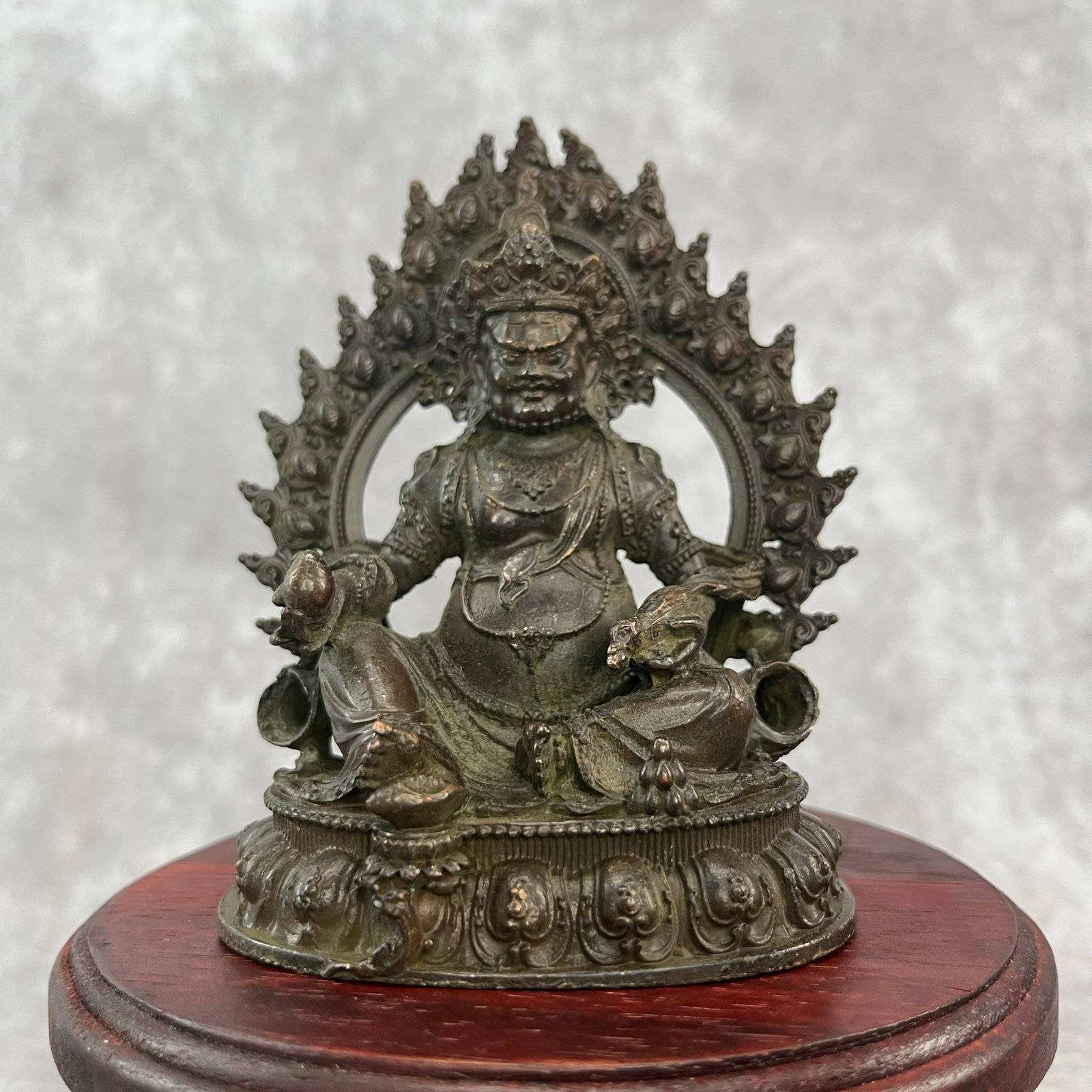 A SMALL BRONZE FIGURE OF JAMBHALA (GOD OF WEALTH): 20th Century; Width:3.7 inch; High: 4.5 inch; wooden base for picture and display purpose only.