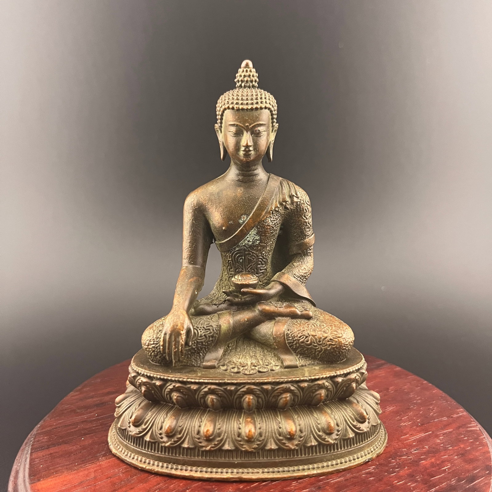 A FINE SMALL BRONZE SHAKYAMUNI BUDDHA: 19th Century; Long: 3 inch; Width: 2.3 inch; High: 3.9 inch; wooden base for picture and display purpose only.