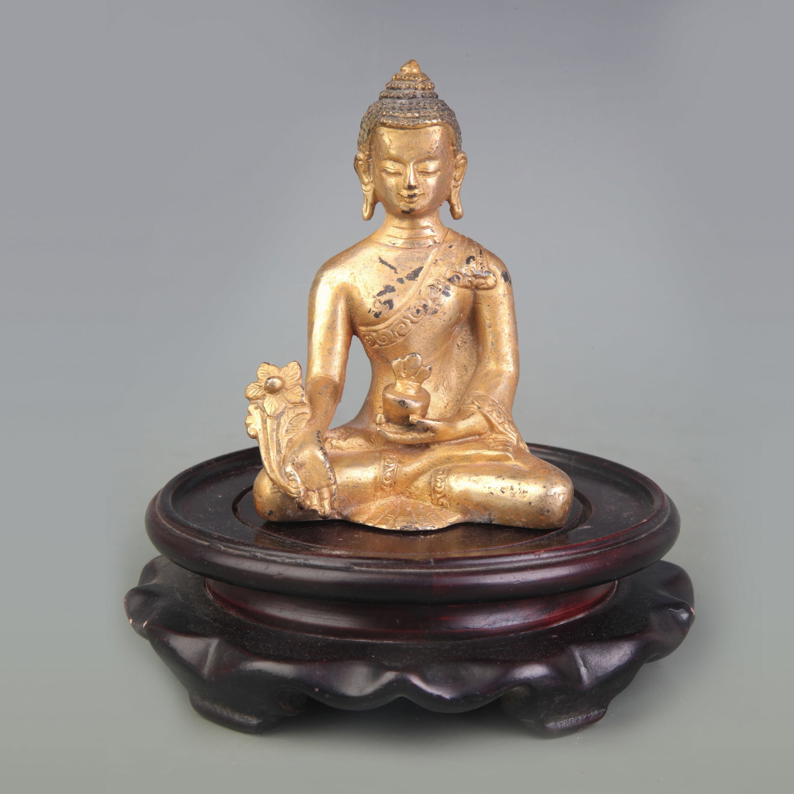 A FINE BRONZE MEDICINE BUDDHA (BHAISAJYAGURU): Qing Dynasty; High:4.0 inch; wooden base for picture and display purpose only.