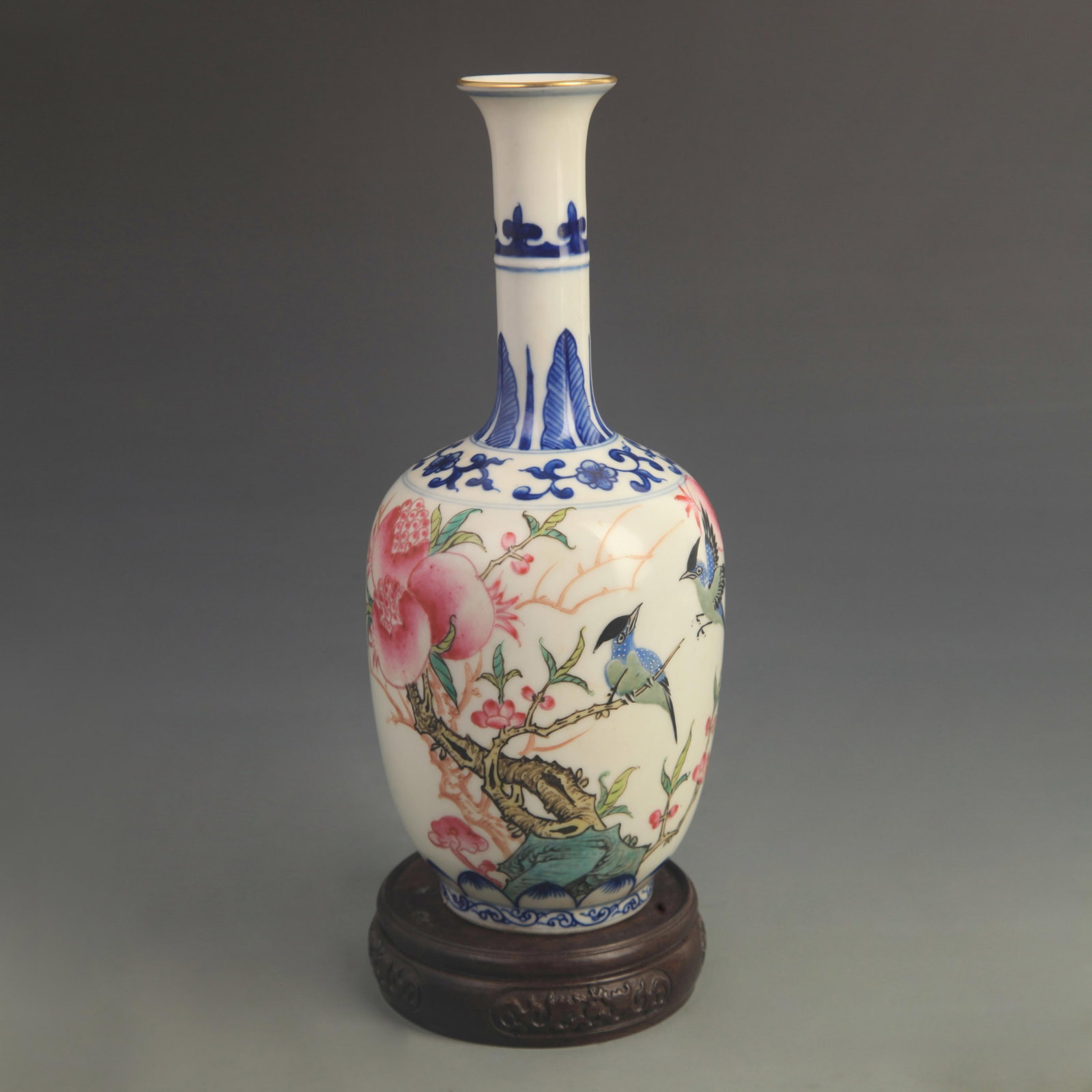 FAMILLE ROSE ENAMEL LONG-NECKED VASE WITH BIRD AND FLOWER DECORATION: Qing Dynasty Qian Long Period; High: 9.40 inch; Diameter: 3.80 inch; wooden base for picture and display purpose only.