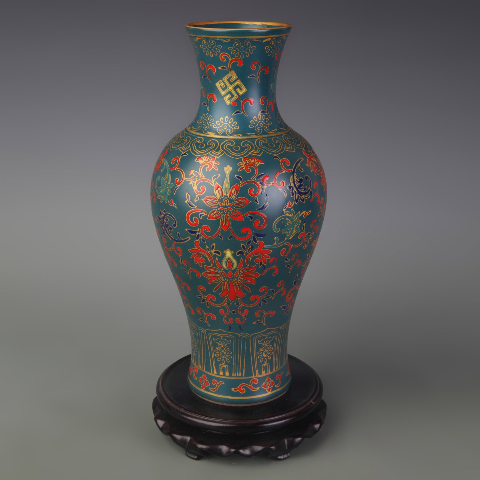 A GREEN-GLAZED VASE WITH ADDED ENAMEL FLORAL DECORATION: Qing Dynasty; Diameter: 2.8 inch; High: 10.4 inch; wooden base for picture and display purpose only.