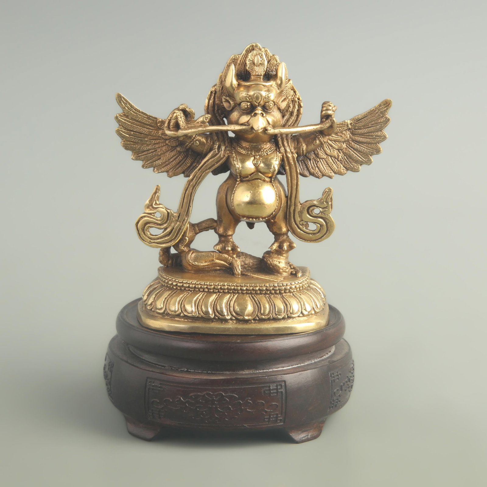 A FINE GILDED BRONZE GARUDA BUDDHA STATUE: 20th Century; High: 5.10 inch; Width: 9.00 inch; Long: 3.80 inch; wooden base for picture and display purpose only.