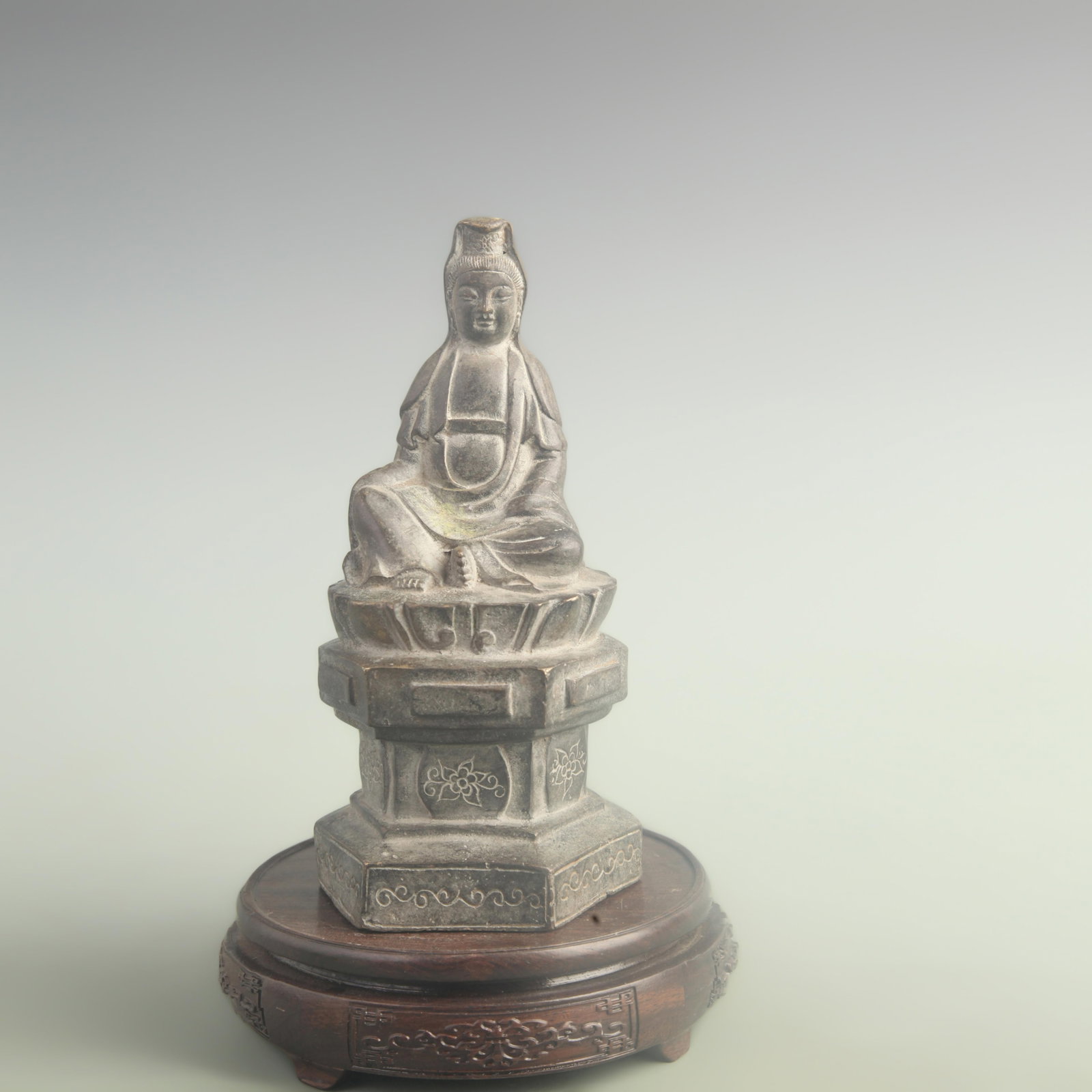 A SEATED BRONZE GUANYIN FIGURE: Qing Dynasty Qian Long Period; High: 8.80 inch; Width: 4.00 inch; Long: 4.00 inch; wooden base for picture and display purpose only.