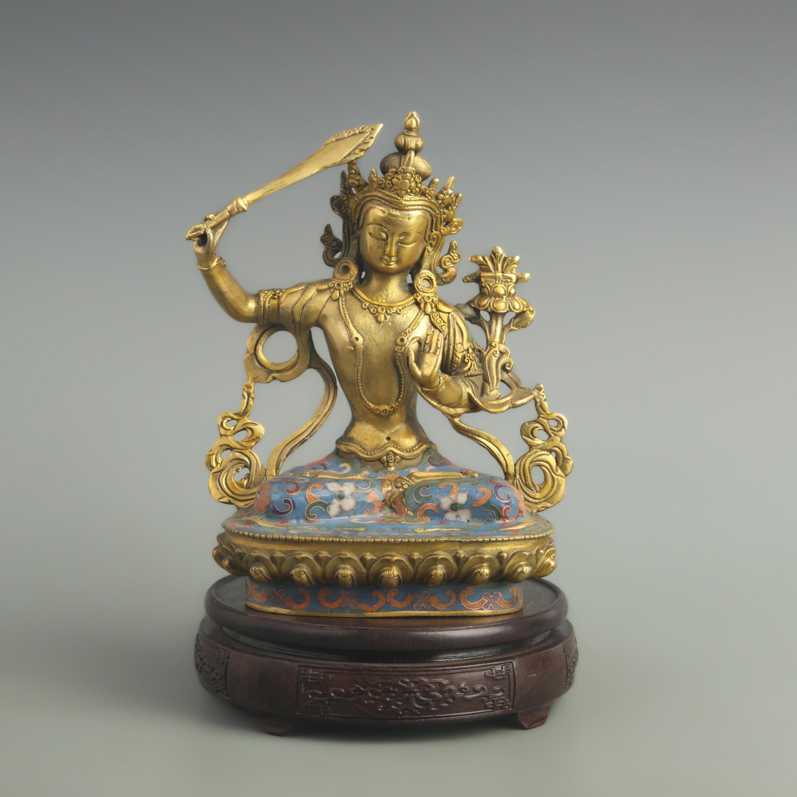 A BRONZE CLOISONNE ENAMEL MANJUSHRI FIGURE: 19th Century; High: 8.20 inch; Width: 2.80 inch; Long: 4.50 inch;; wooden base for picture and display purpose only.