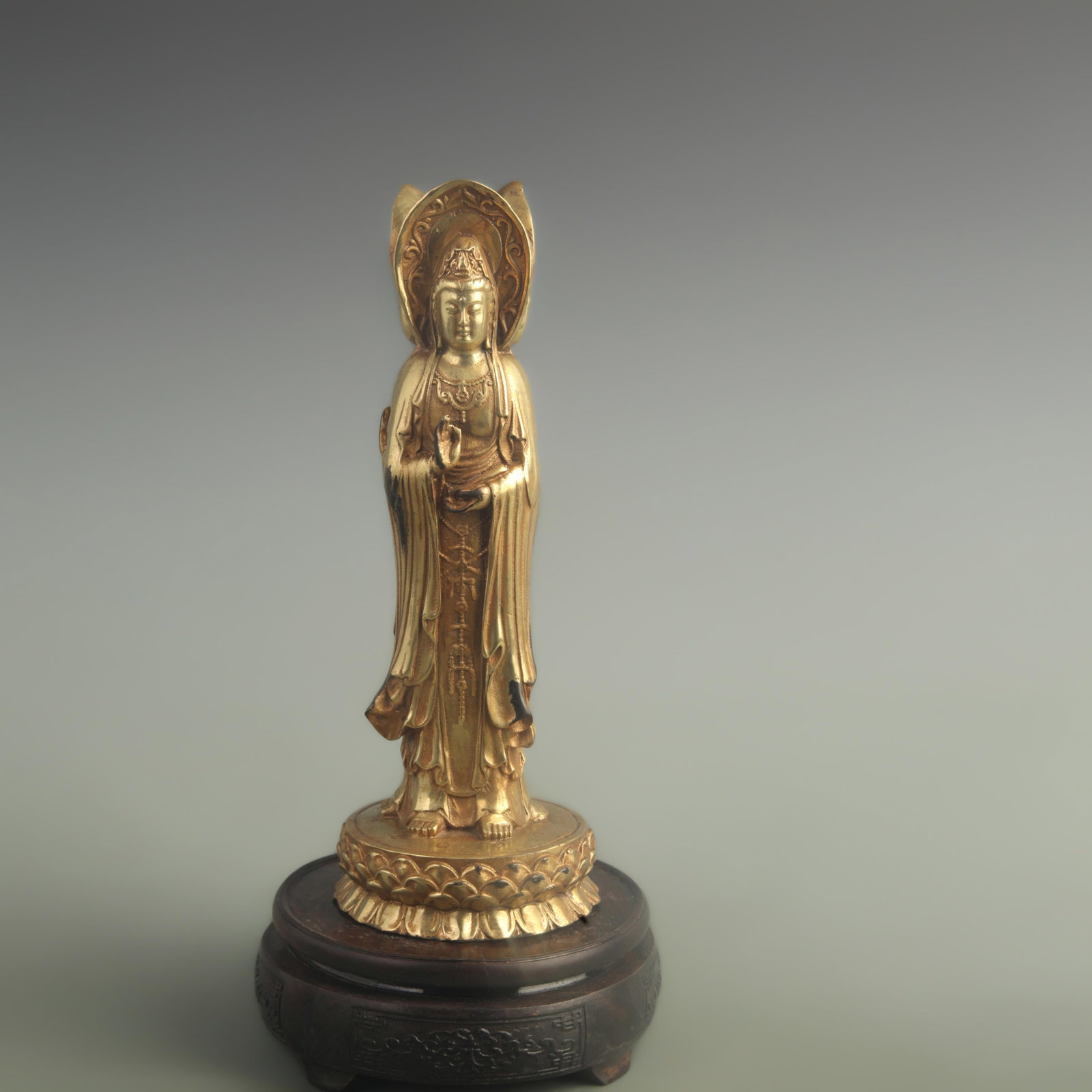 A GILT BRONZE THREE-FACED GUANYIN FIGURE: Qing Dynasty Qian Long Period; High: 9.80 inch; Diameter: 3.80 inch; wooden base for picture and display purpose only.