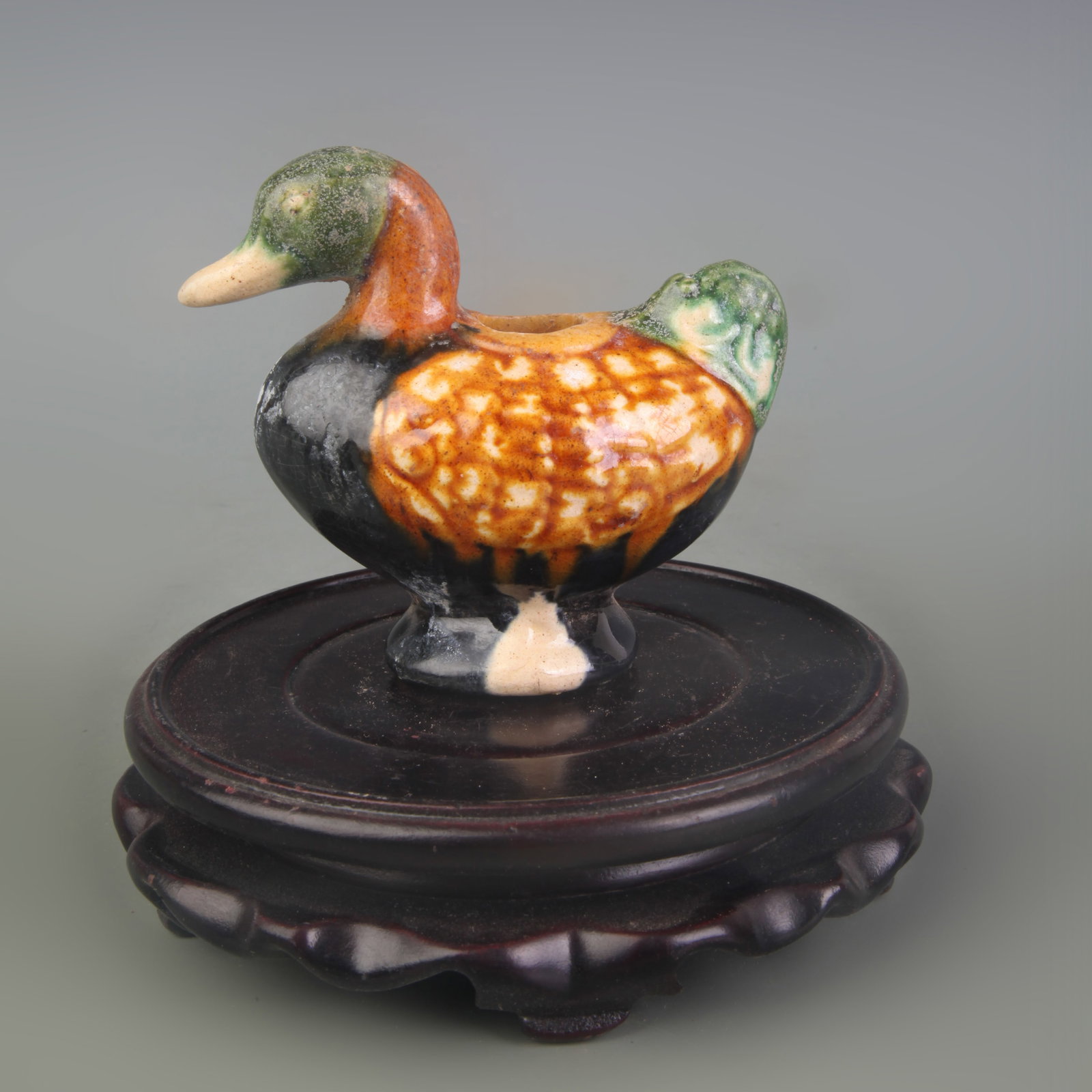 A FINE SANCAI COLOR DUCK-SHAPED WATER EWER: Tang Dynasty Style; High: 3.2in; wooden base for picture and display purpose only.