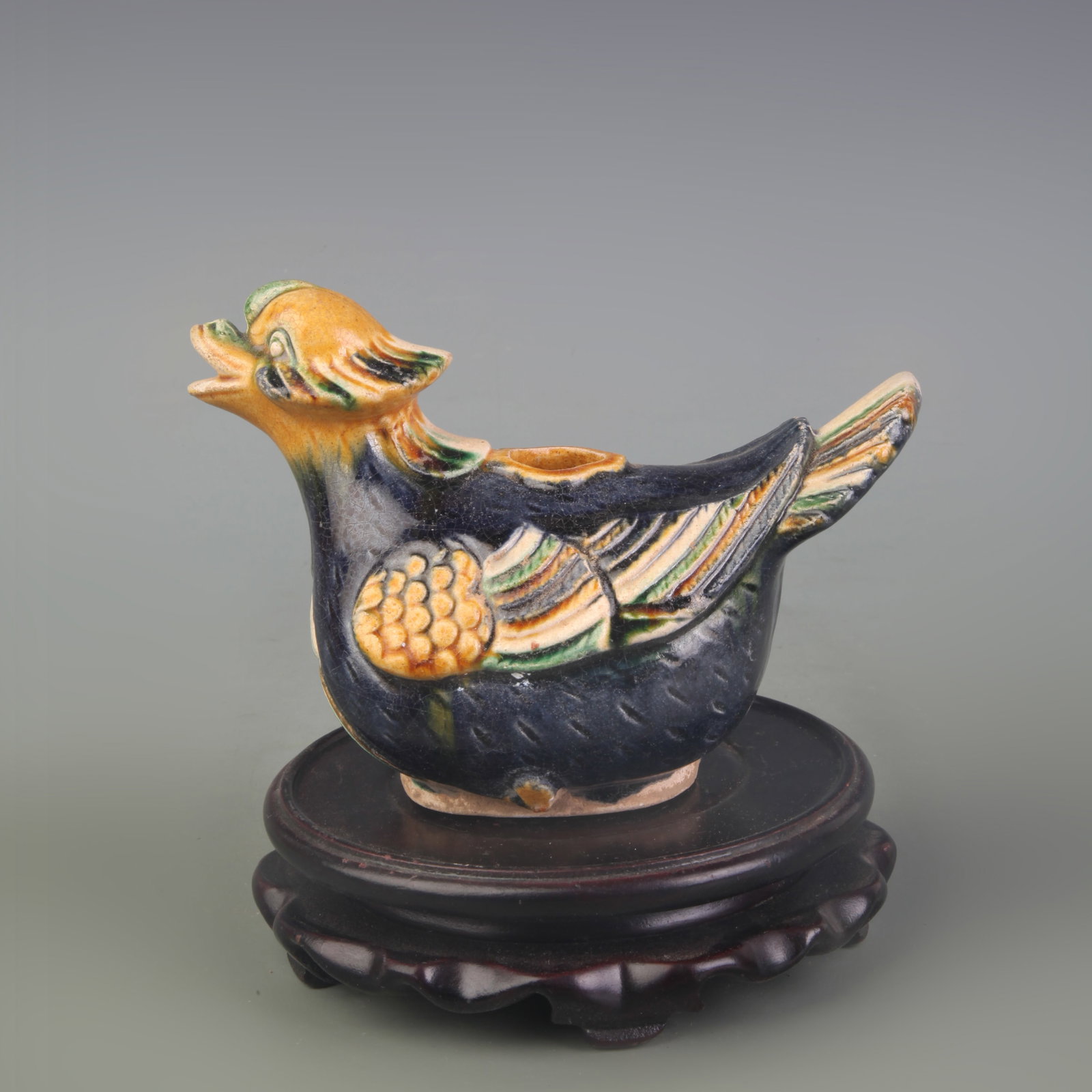 A FINE SANCAI COLOR DUCK-SHAPED WATER EWER: Tang Dynasty Style; Long: 5.9 inch; High: 40.0 inch; wooden base for picture and display purpose only.