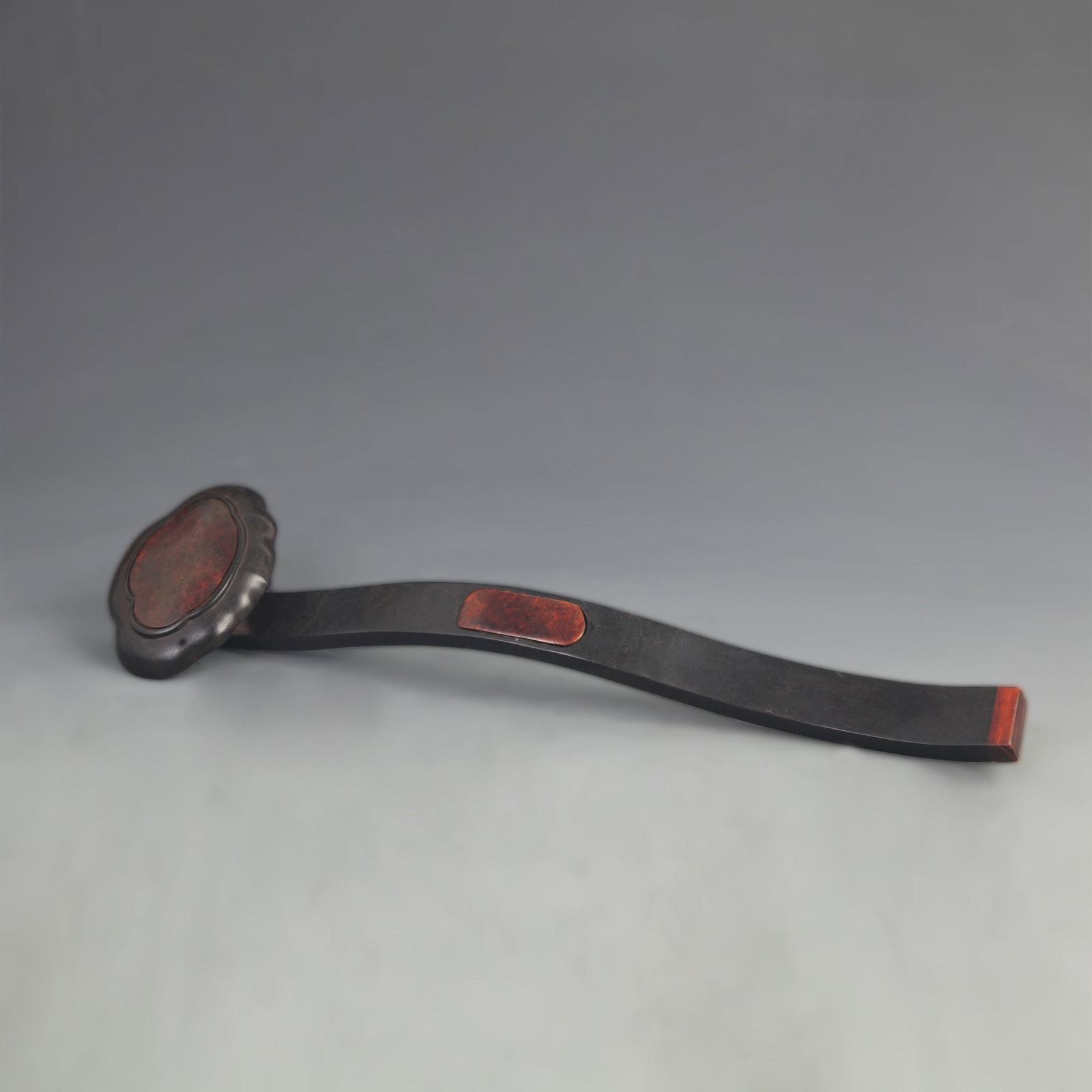 A BLACKWOOD RUYI SCEPTRE INLAID WITH CHERRY WOOD: 20th Century; High: 13.75 inch; Width: 3.60 inch