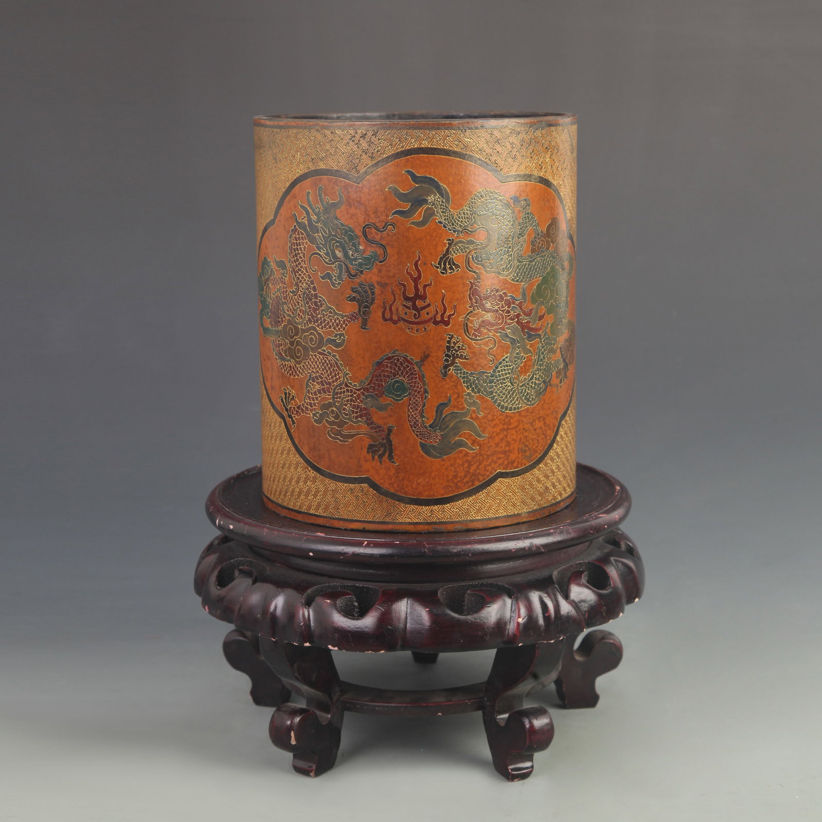 LACQUER BRUSH POT WITH GOLD INCISED DECORATION AND RESERVED PANELS OF DOUBLE DRAGONS PLAYING WITH A: 20th Century; High: 7.75 inch; Diameter: 6.50 inch; wooden base for picture and display purpose only.