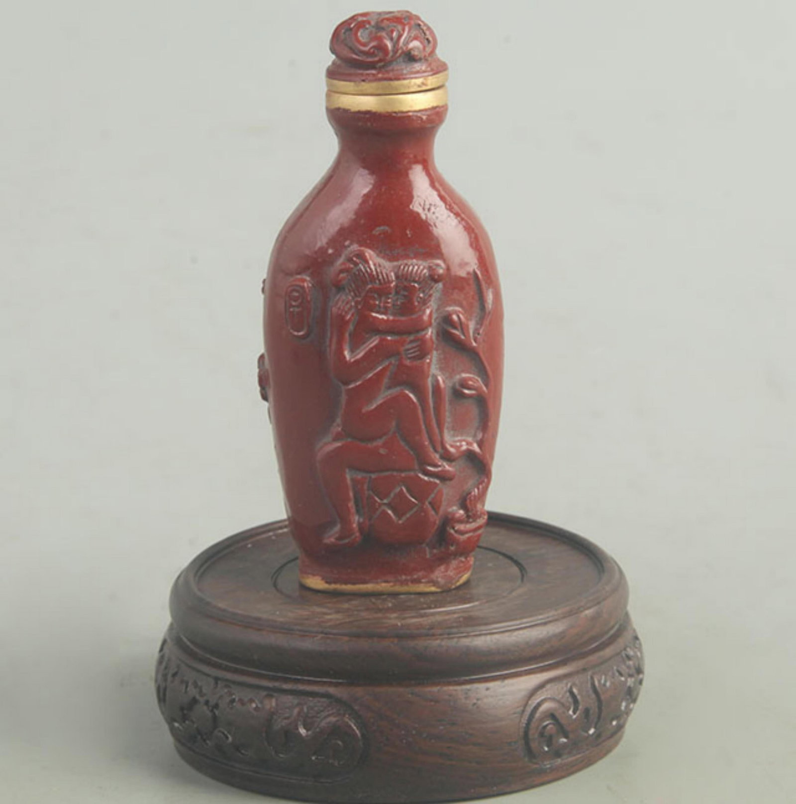 A FINE CARVED LACQUER CHARACTER PATTERN SNUFF BOTTLE: Qing Dynasty; High: 3.5 inch; Width: 2.00 inch; wooden base for picture and display purpose only.