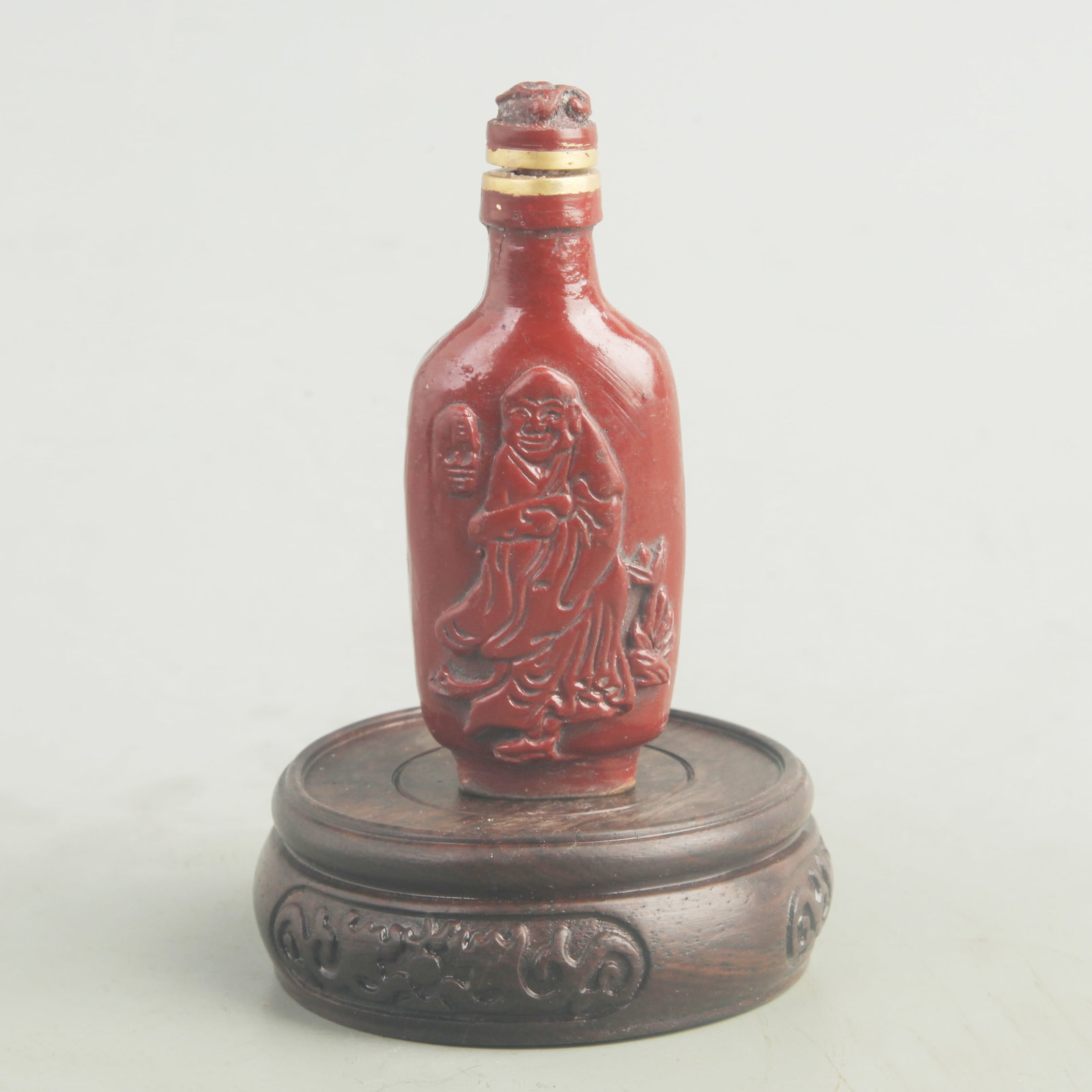 A FINE CARVED LACQUER CHARACTER PATTERN SNUFF BOTTLE: Qing Dynasty; High: 3.75 inch; Width: 1.75 inch; wooden base for picture and display purpose only.