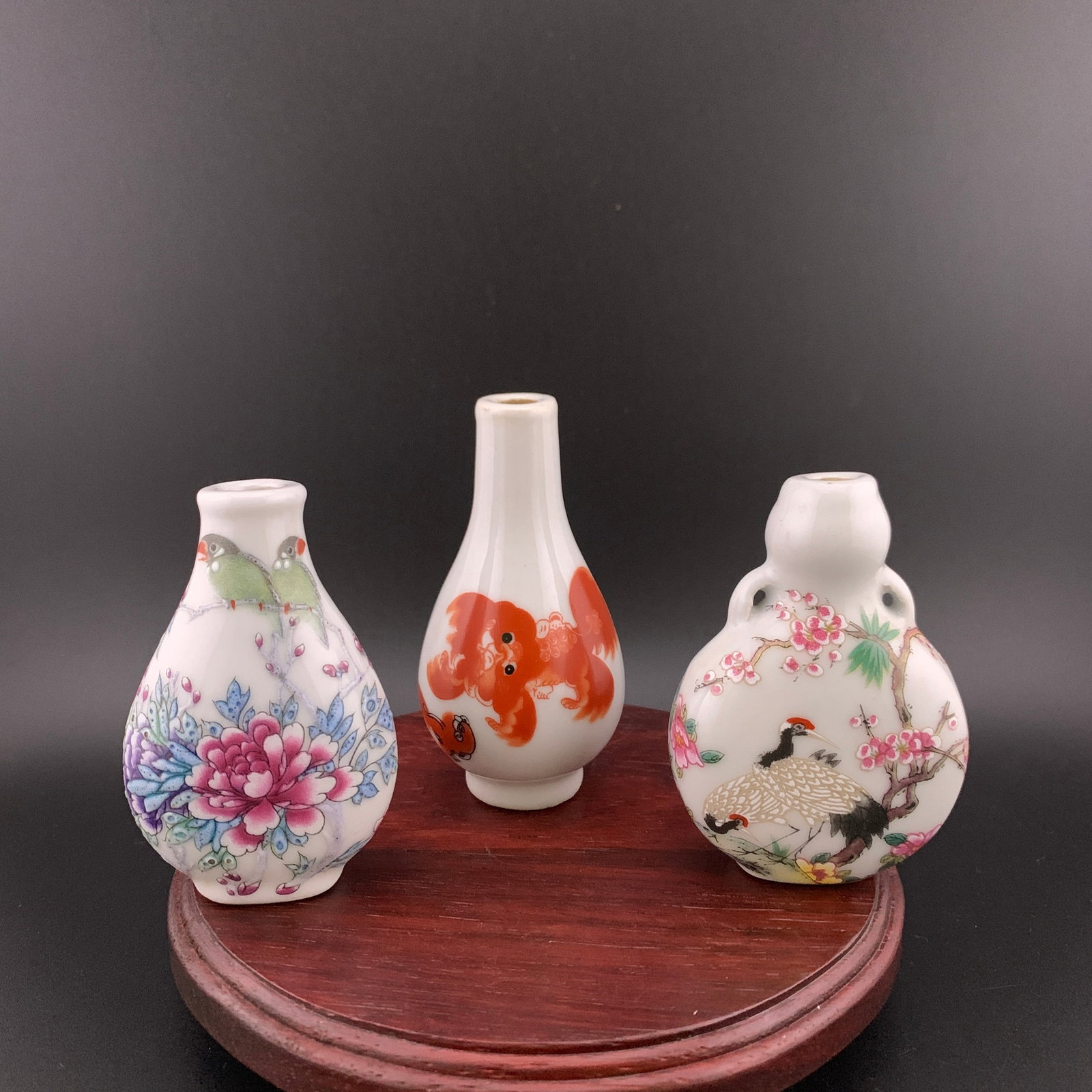 SET OF THREE FAMILLE ROSE PORCELAIN SNUFF BOTTLE: Modern; Long: 2 inch; Width:1.02 inch; High: 2.8 inch; Long: 1.8 inch; Width:1.03 inch; High: 2.78 inch; High: 3.2 inch; Diameter: 1.62 inch; wooden base for picture and display purpose only.