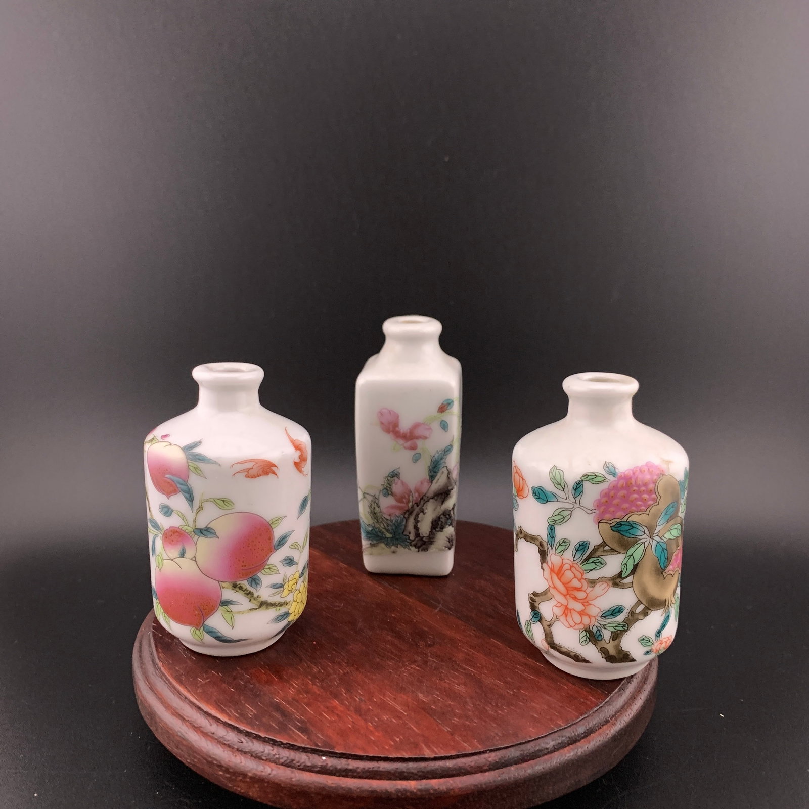 SET OF THREE FAMILLE ROSE PORCELAIN SNUFF BOTTLE: Modern; High: 2.6 inch; Diameter: 1.5 inch; High: 2.6 inch; Diameter: 1.5 inch; Long: 1.12 inch; Width:1.12 inch; High: 2.9 inch; wooden base for picture and display purpose only.