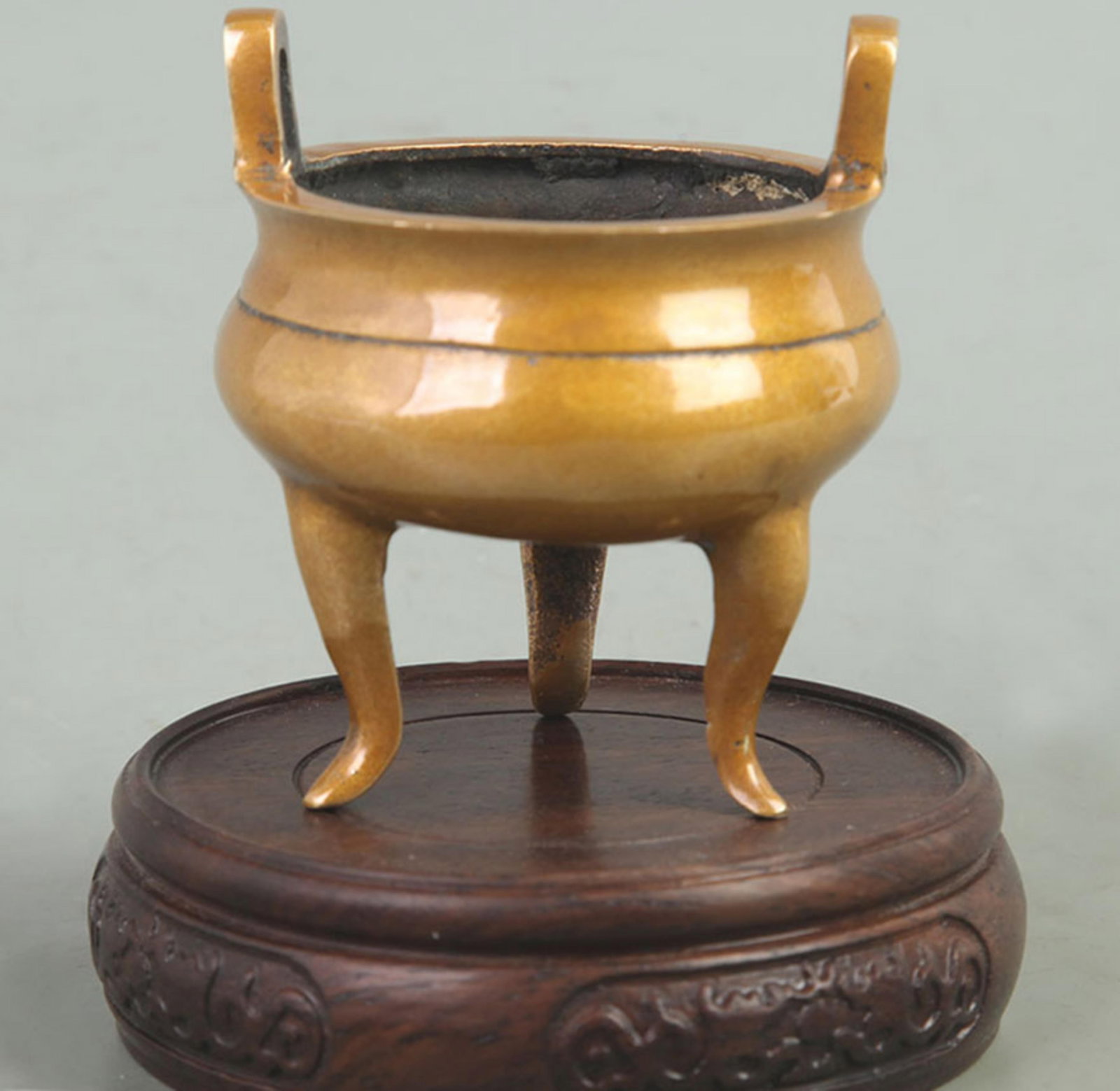A TALL TRI LEGGED BRONZE CENSER WITH UPRIGHT EARS: Qing Dynasty; High: 3.30 inch; Diameter: 2.70 inch; wooden base for picture and display purpose only.